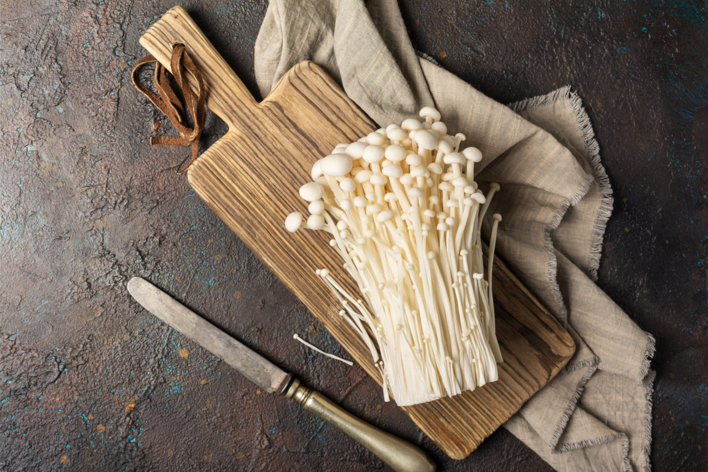 enoki mushroom on cutting board