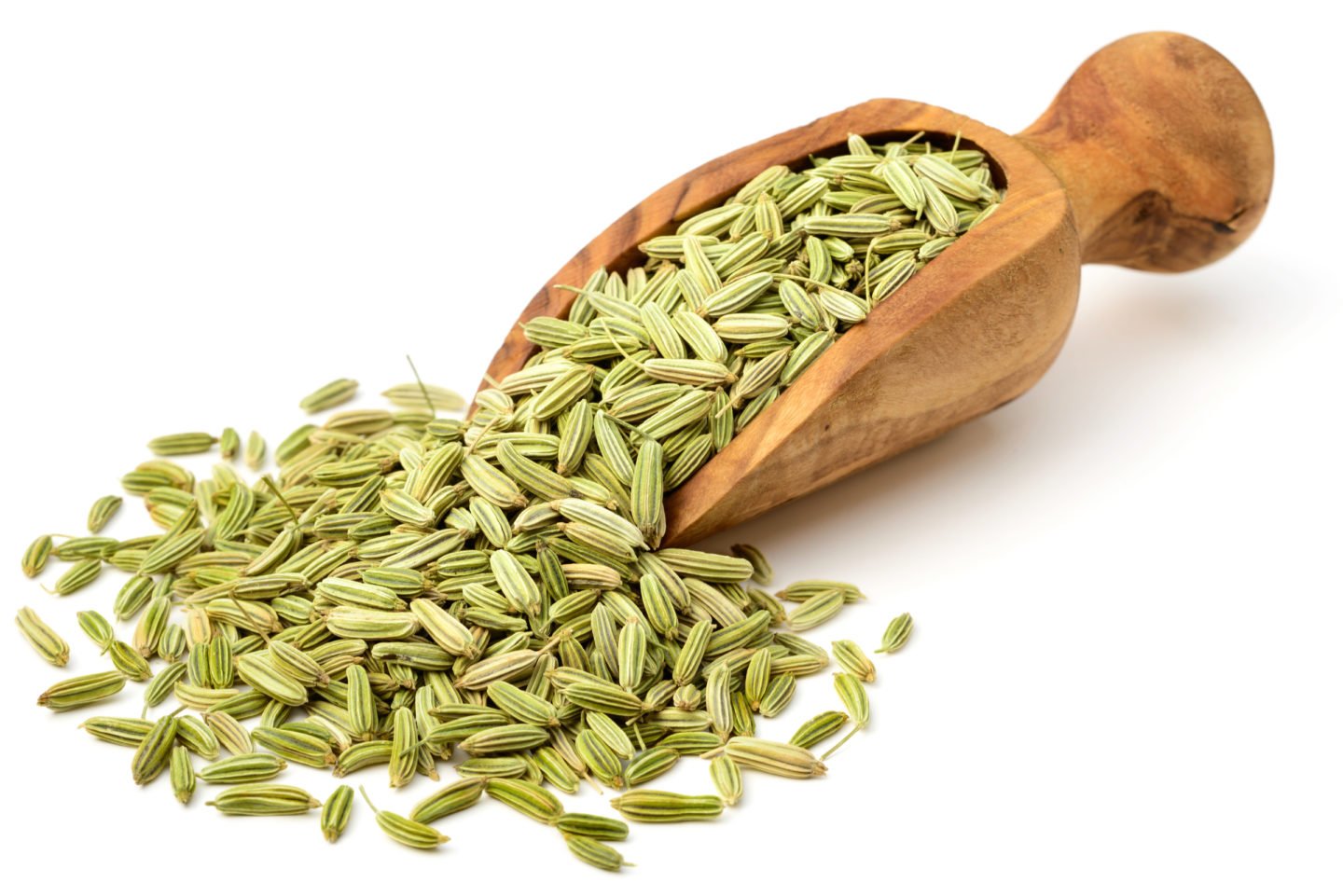 fennel seeds spilled from a wooden scoop