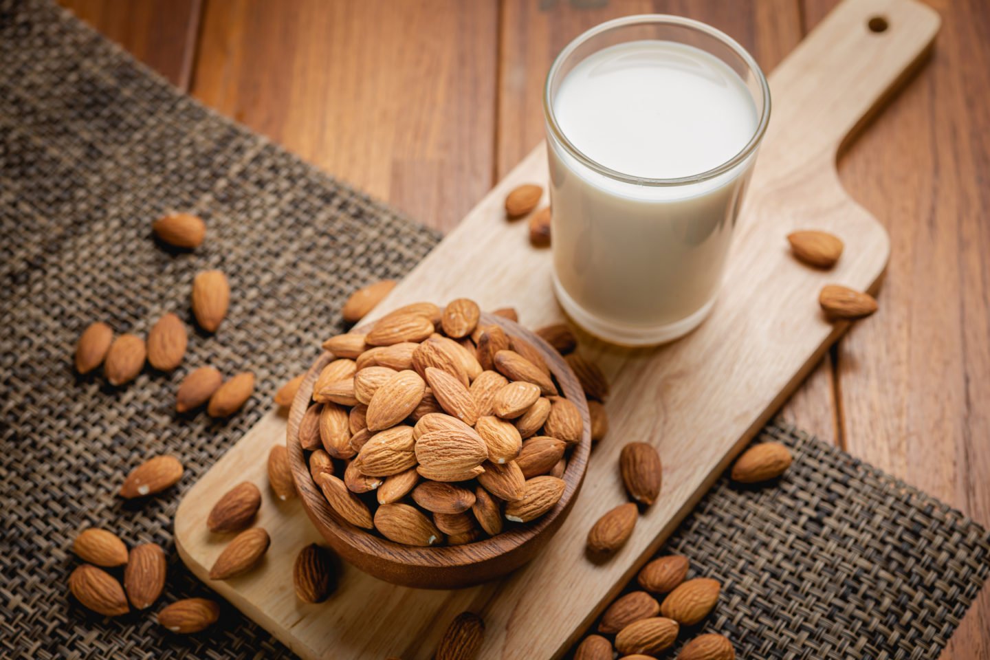 glass of almond milk and nuts