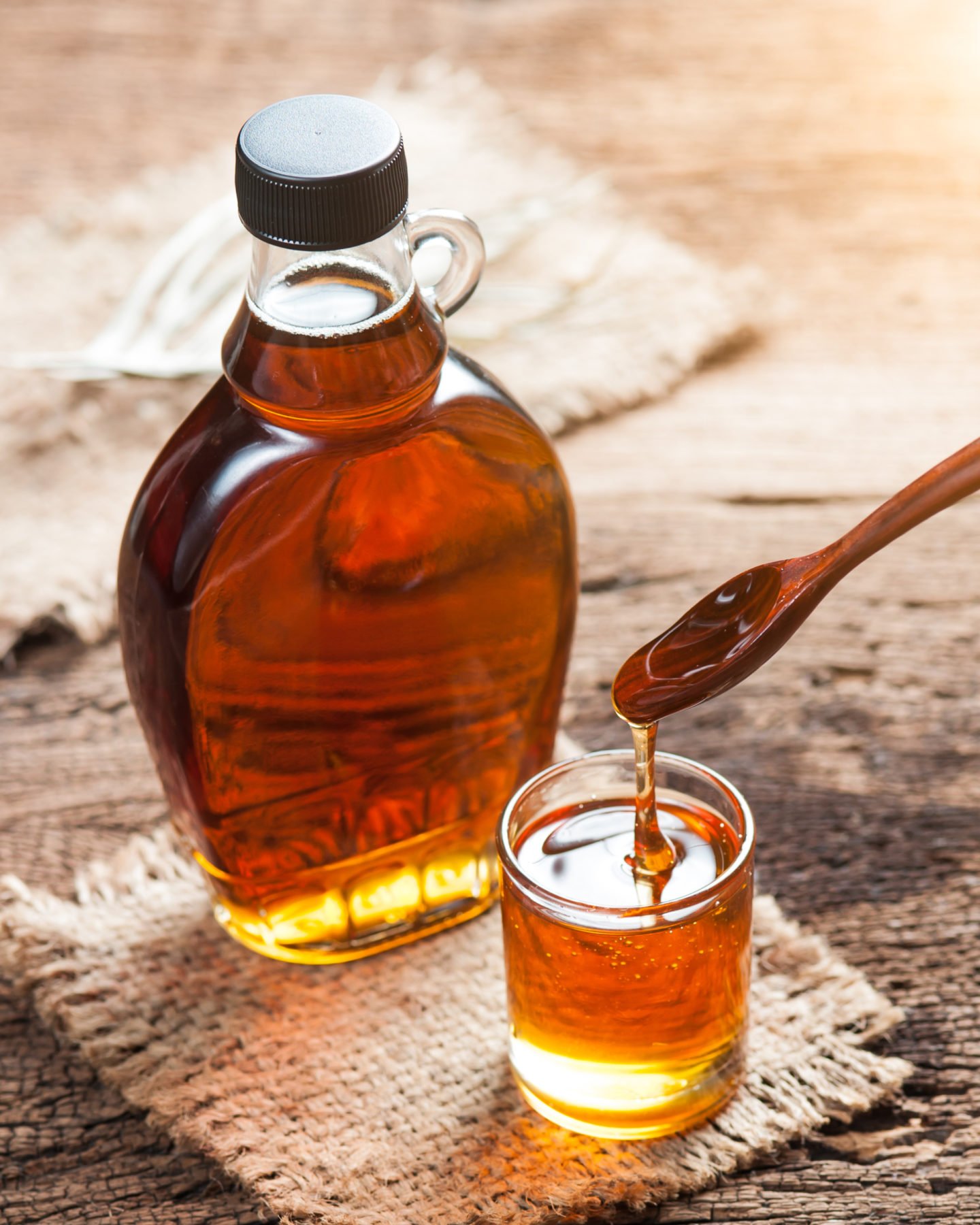 maple syrup in bottle spoon and small glass