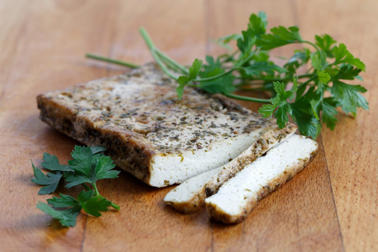 a slice of marinated tofu on wooden surface
