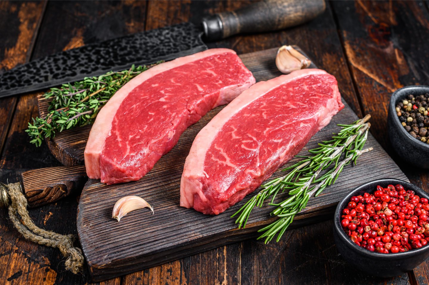 uncooked top sirloin steak on cutting board