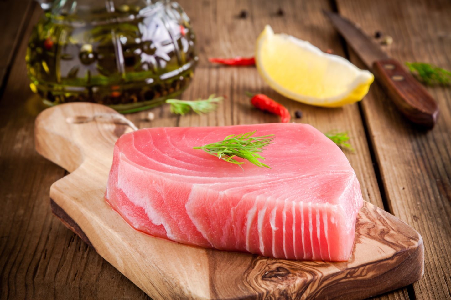 uncooked tuna fillet on cutting board