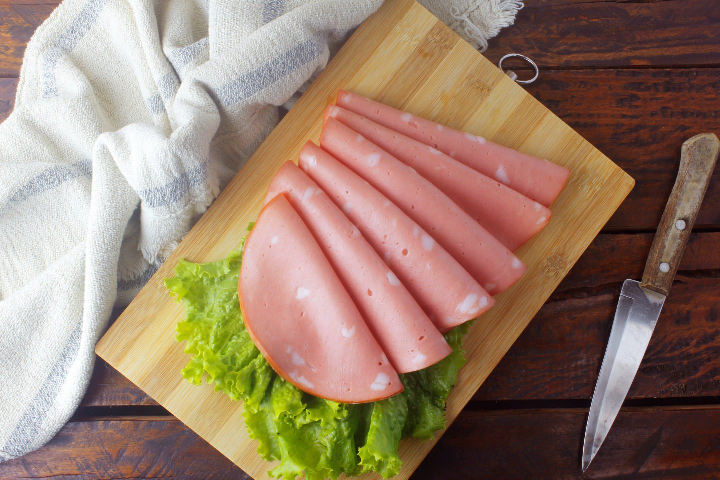 slices of mortadella on cutting board