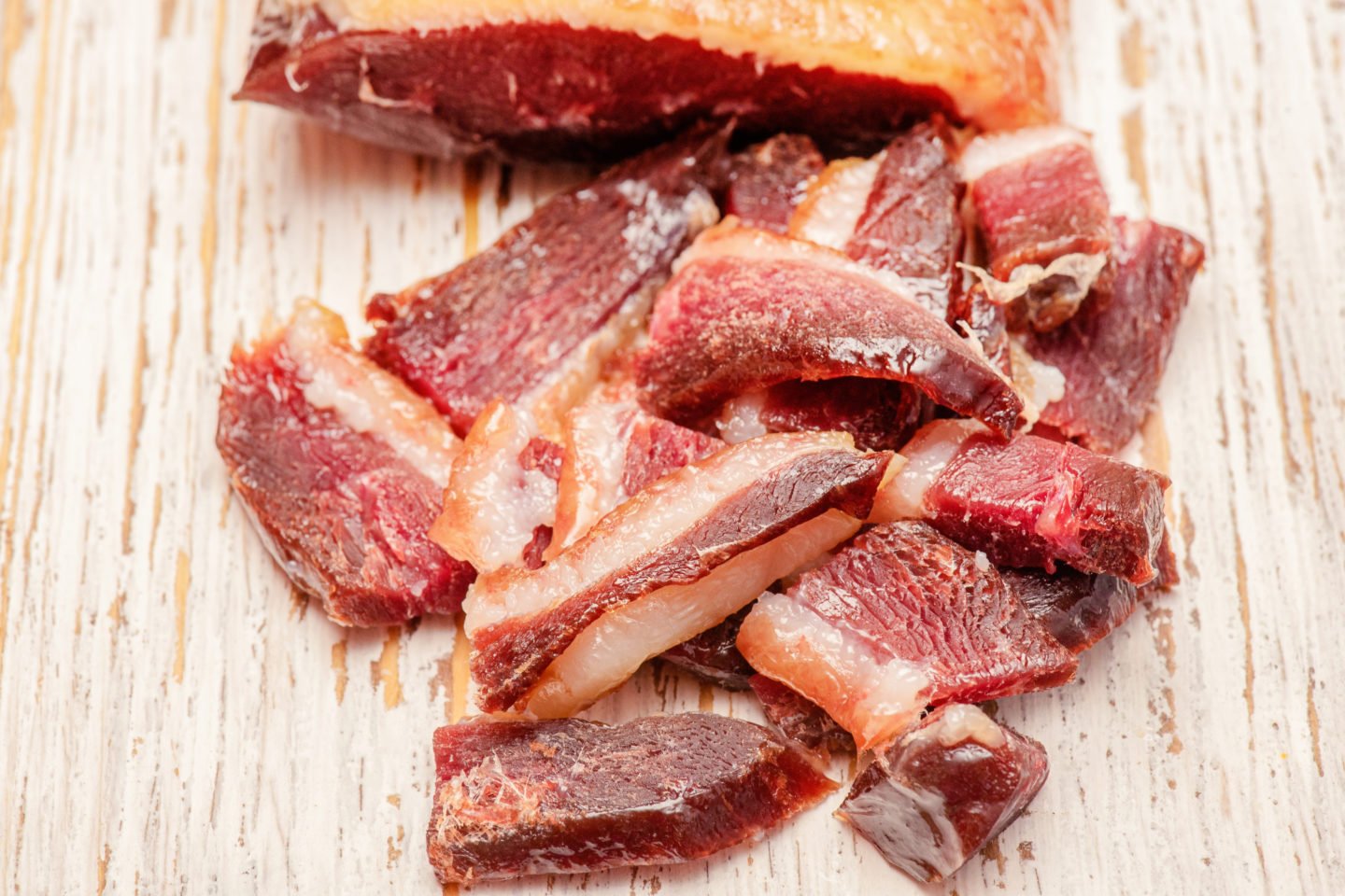 duck prosciutto slices on wooden surface