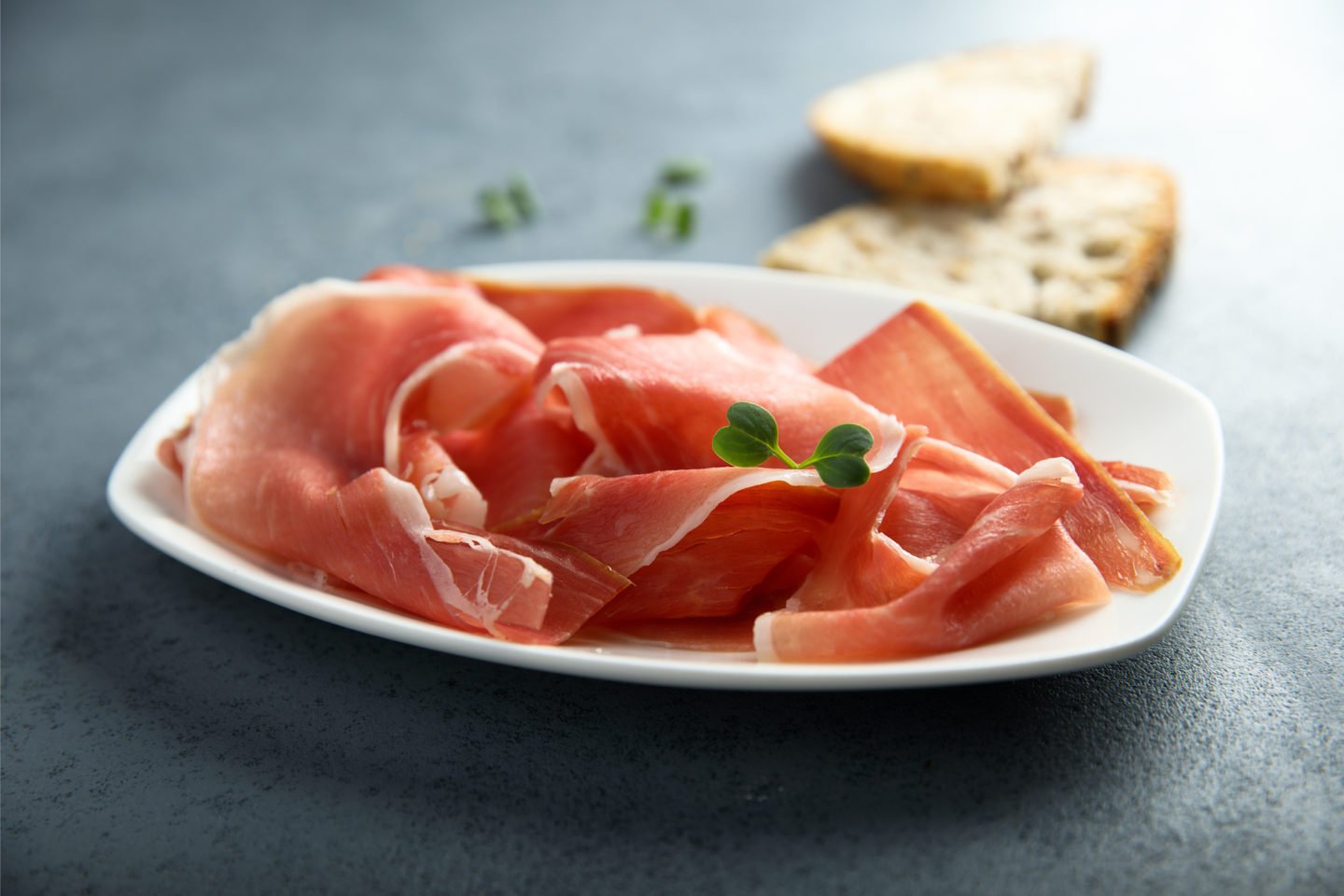 serrano ham slices on white plate