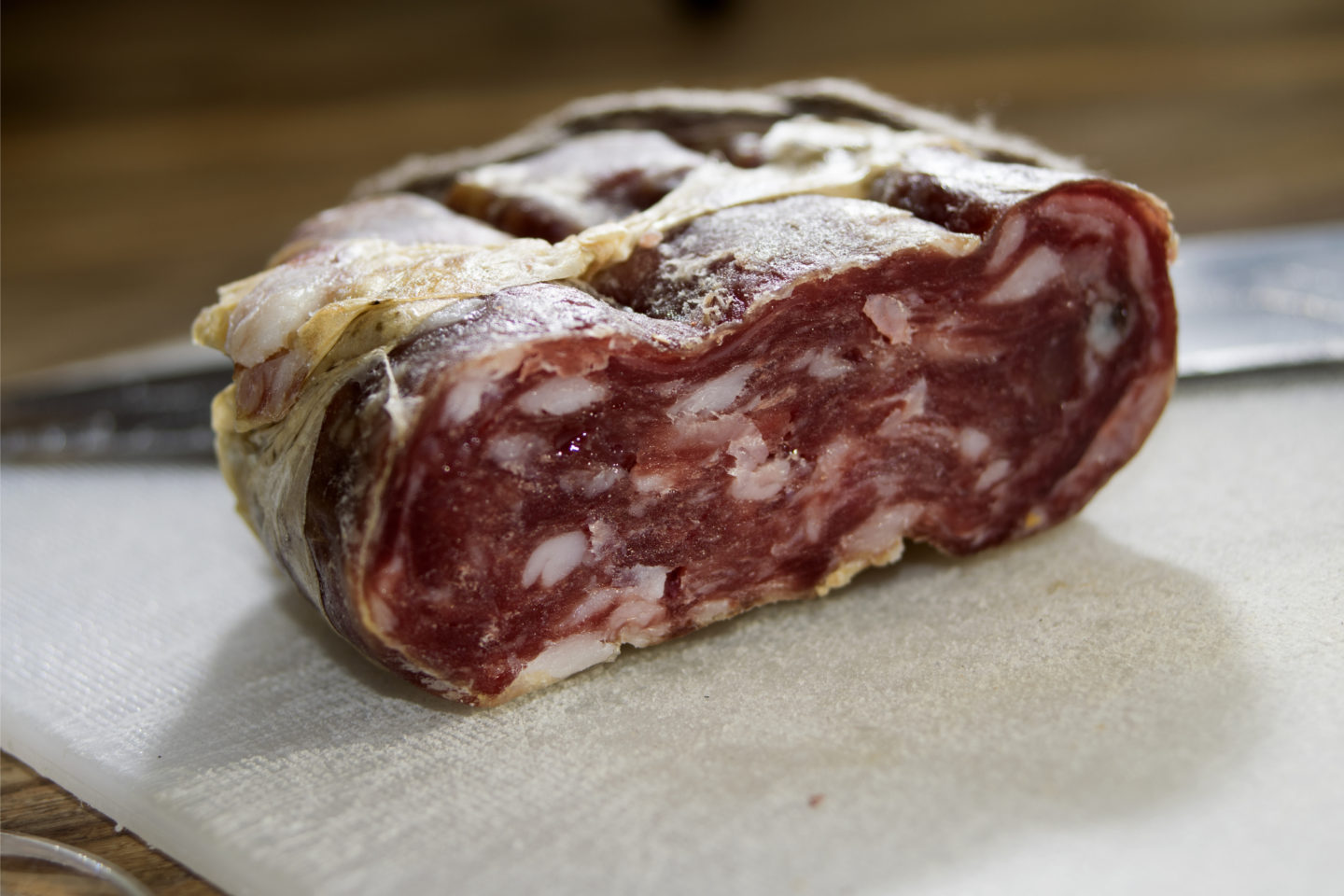 block of soppressata on cutting board