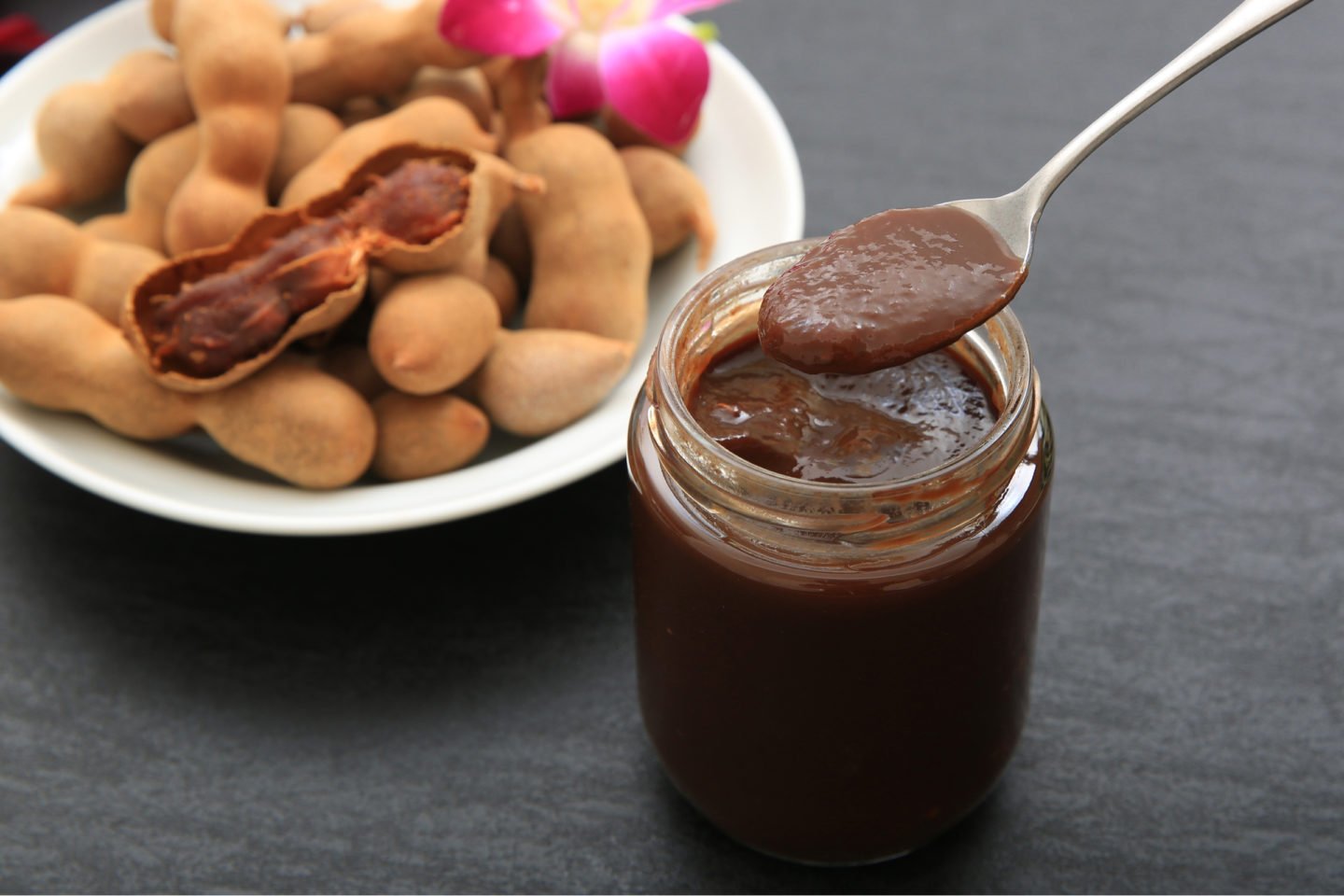 tamarind paste in a jar with tamarind fruits