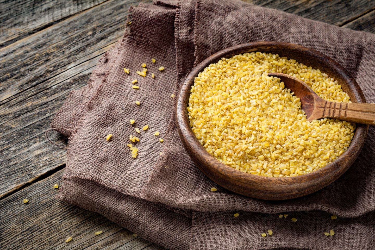 bowl of uncooked bulgur with spoon