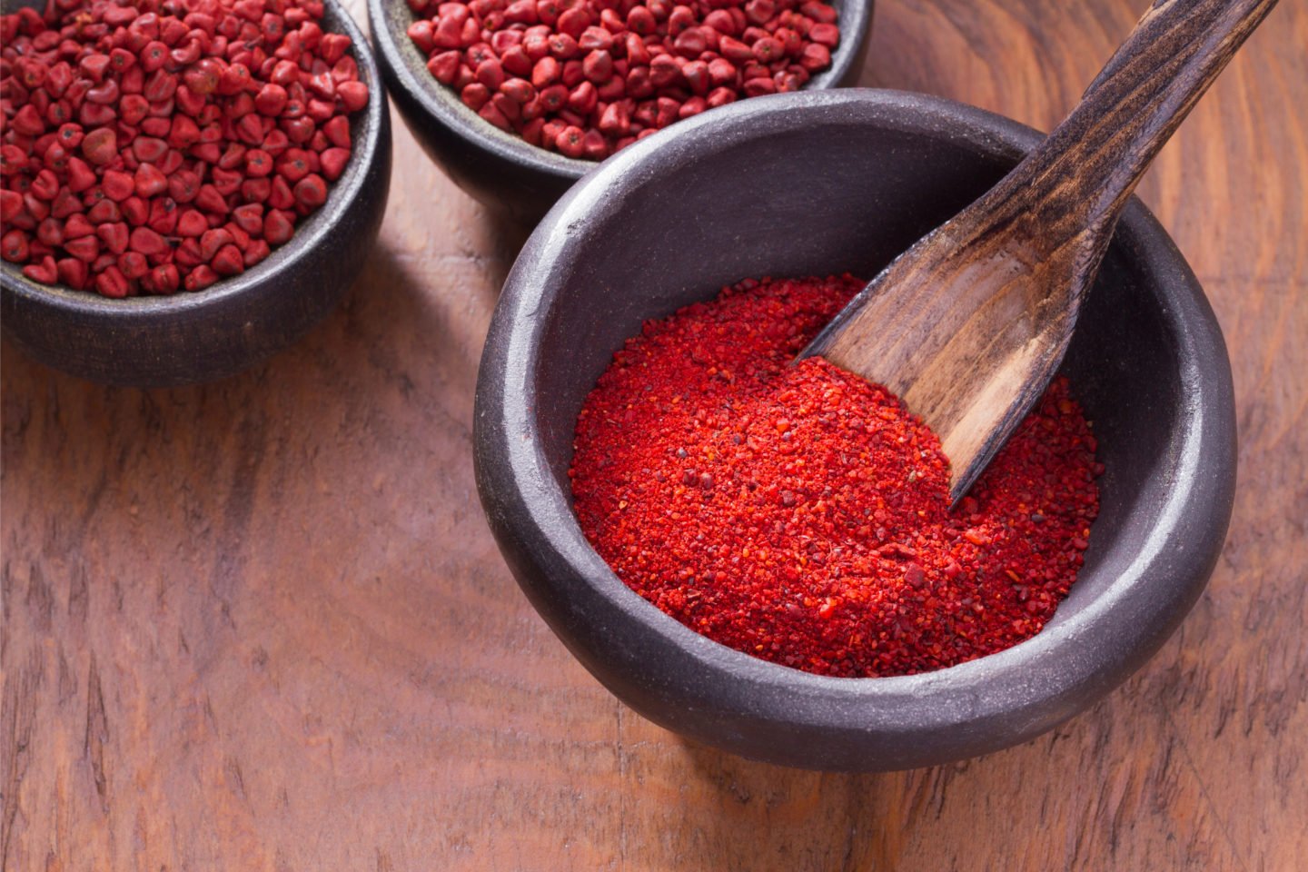 Achiote Powder In Wooden Bowl With Spoon