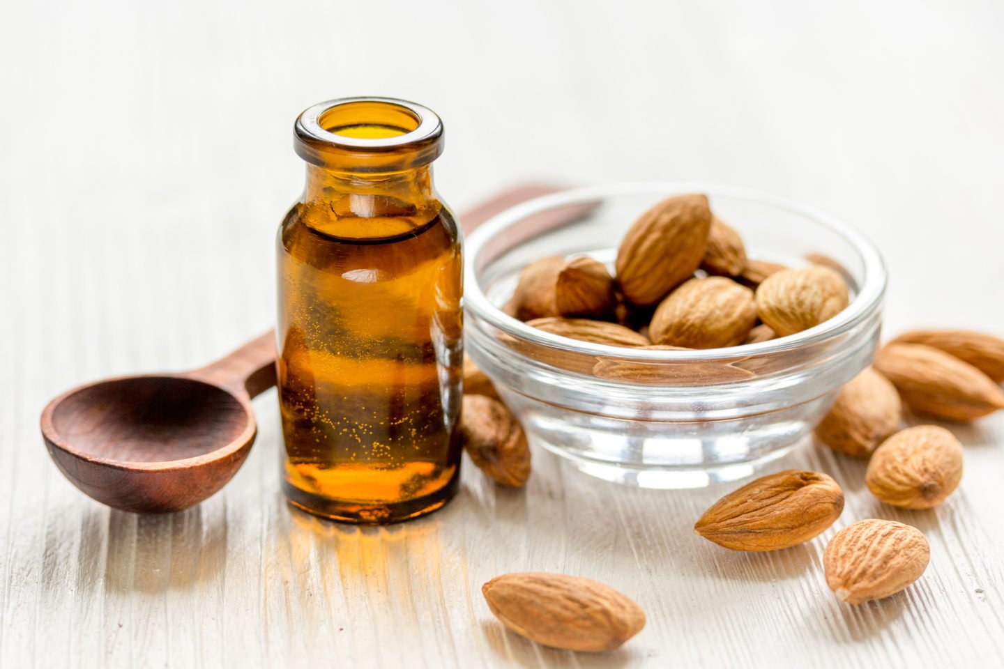 Almond Extract In Glass Bottle Beside Almonds