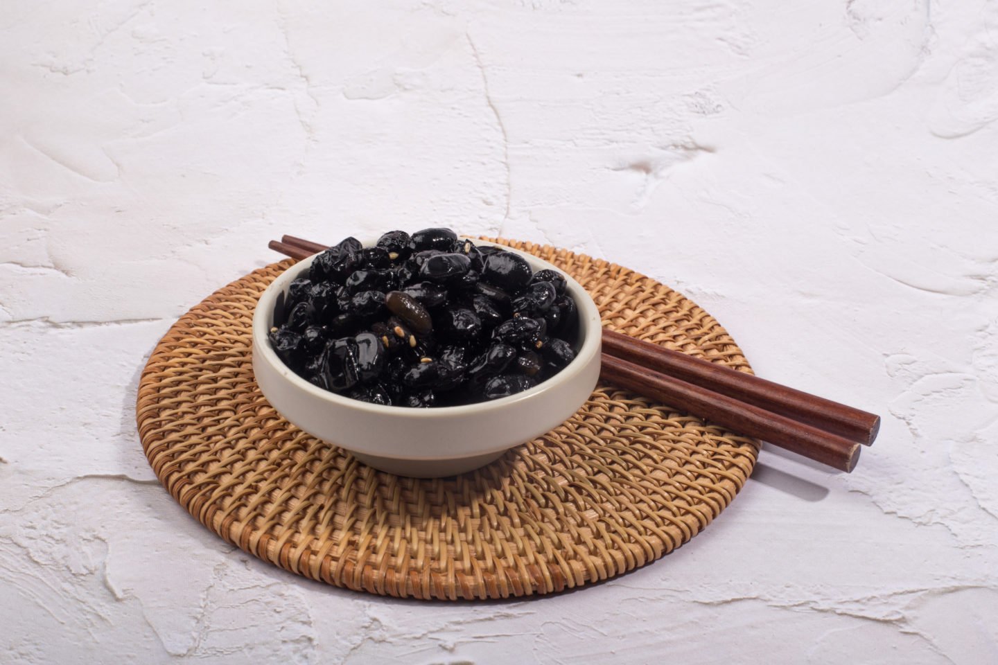 Black Beans In White Bowl With Chopsticks