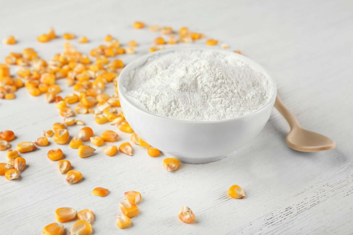 bowl of cornstarch with wooden spoon