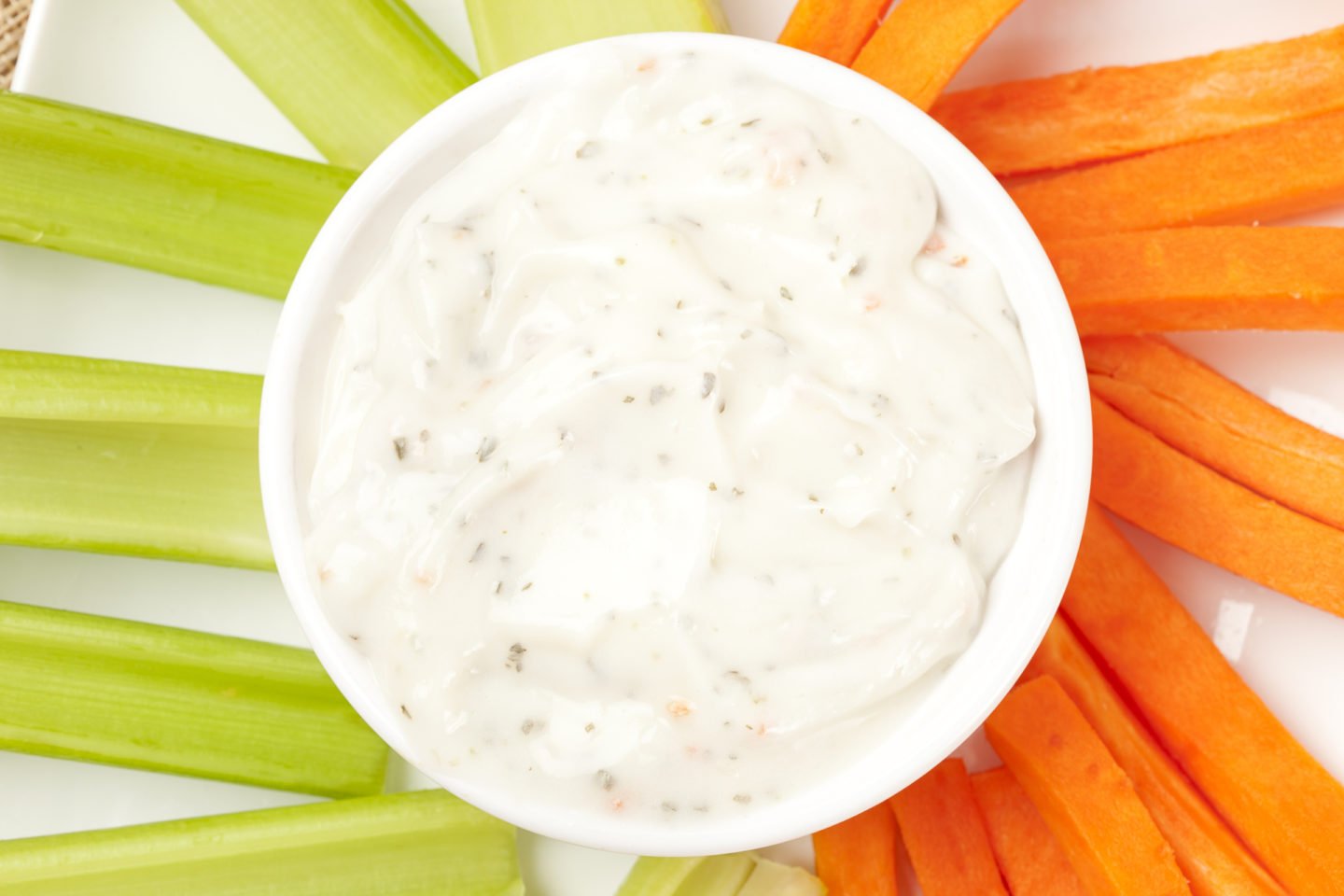 Bowl Of Ranch Dressing With Fresh Carrots And Celery