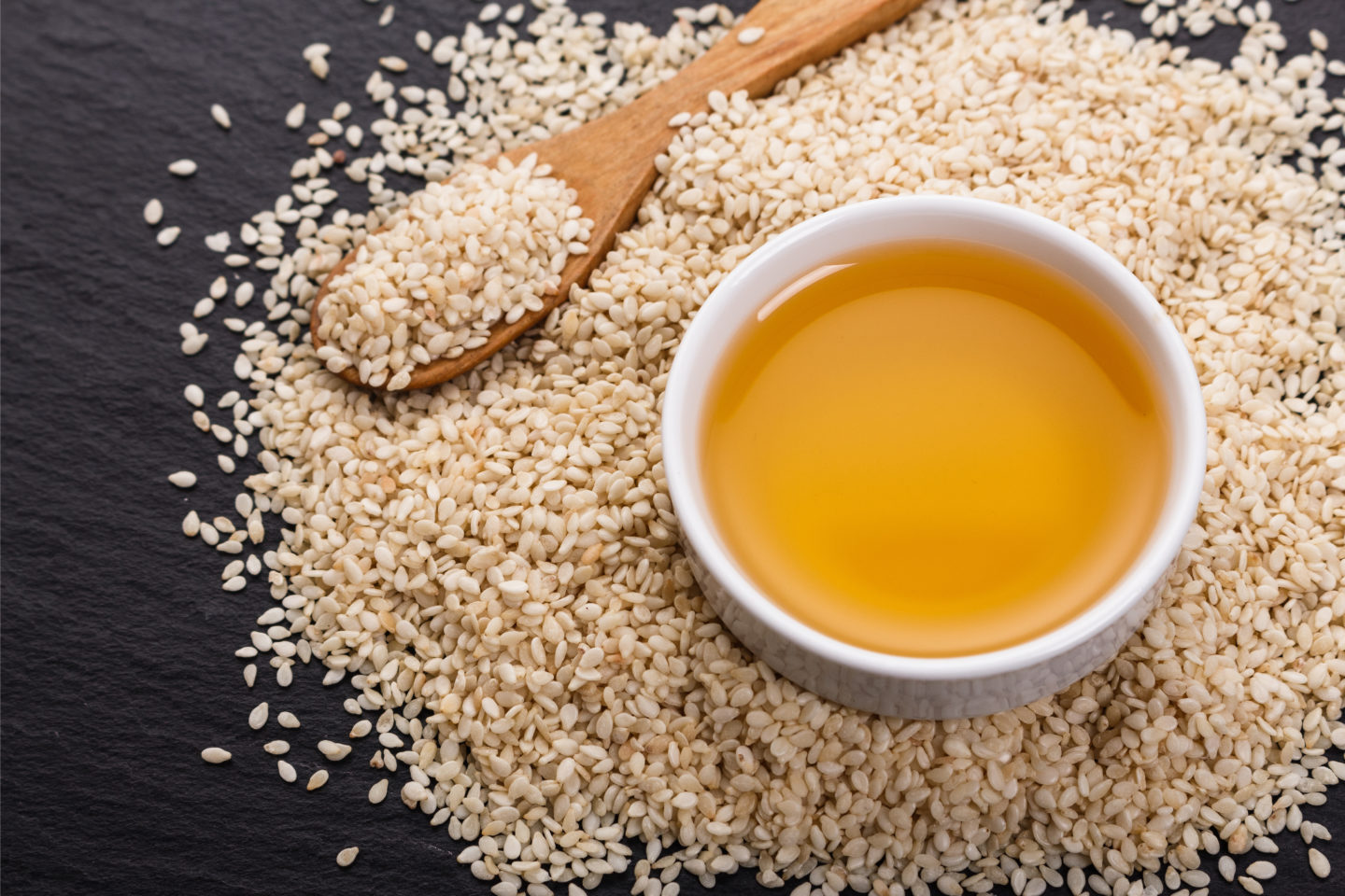 Bowl Of Sesame Oil On Sesame Seeds