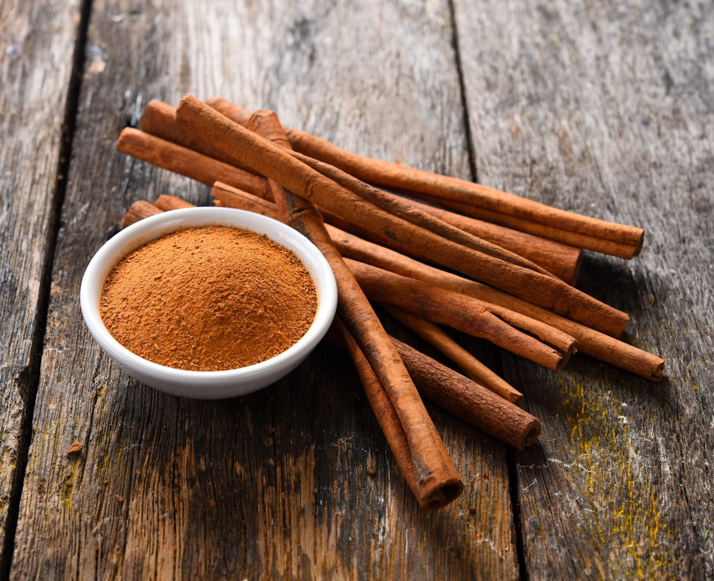 cinnamon sticks and ground cinnamon in bowl