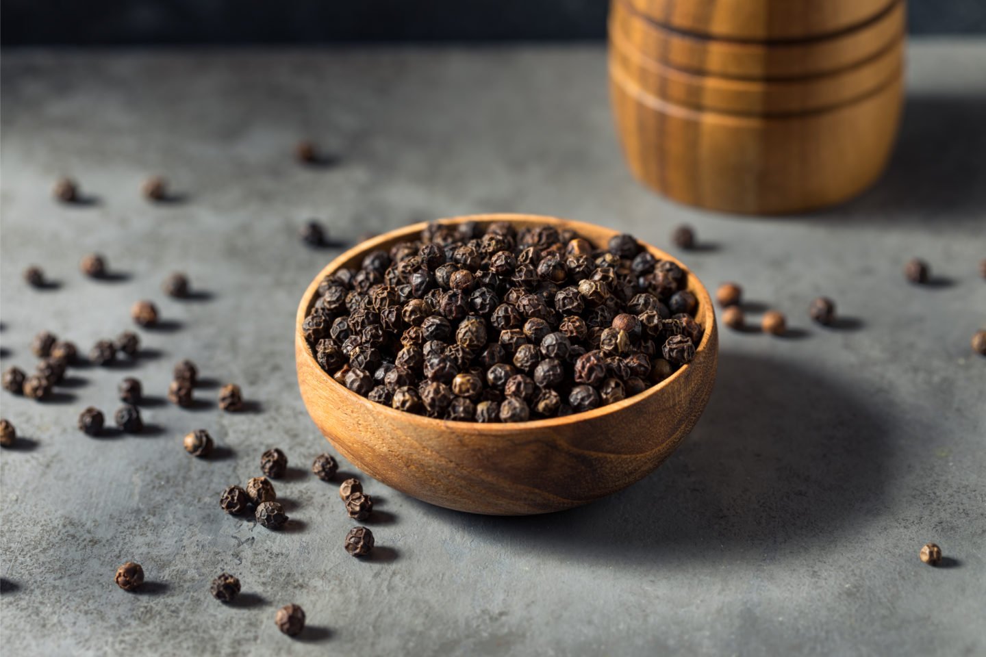 Fresh Dried Black Peppercorn In Wooden Bowl