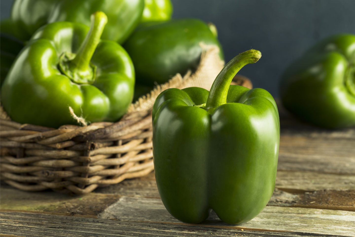 fresh green bell pepper on wooden surface