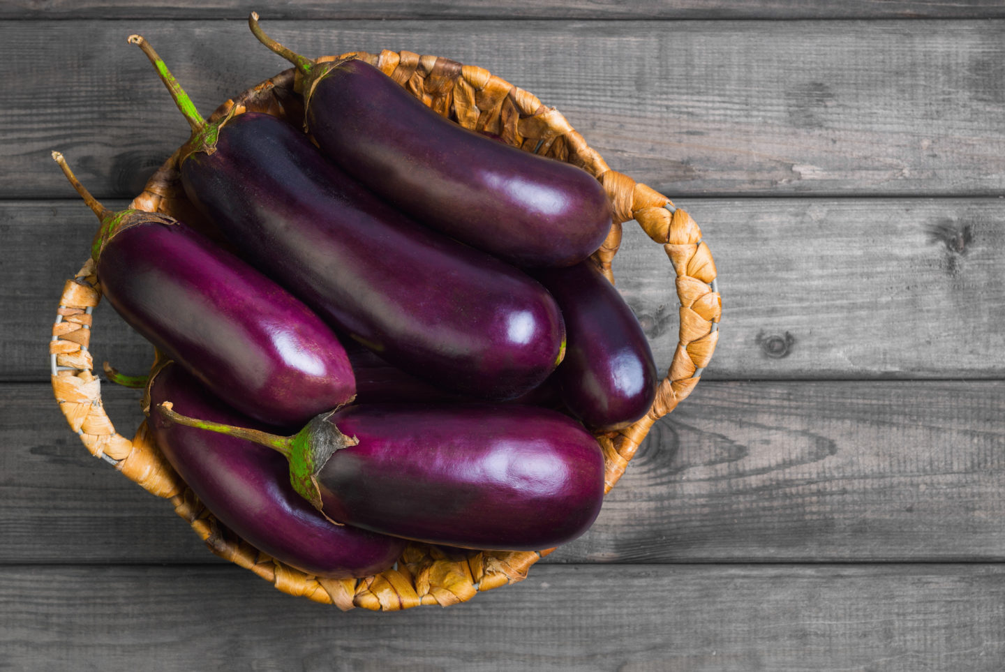 fresh raw eggplant in basket