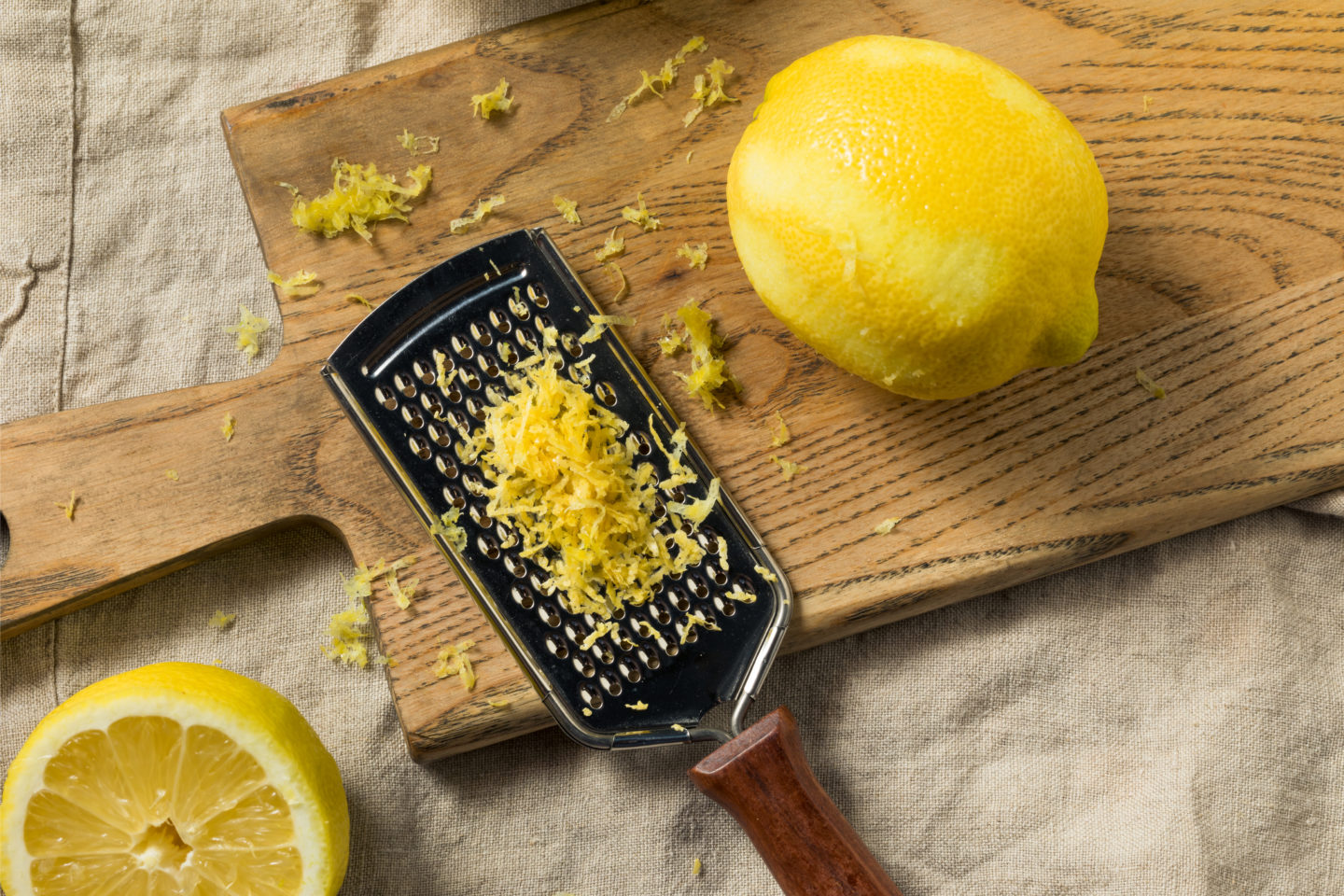 Freshly Grated Lemon Zest On Cutting Board