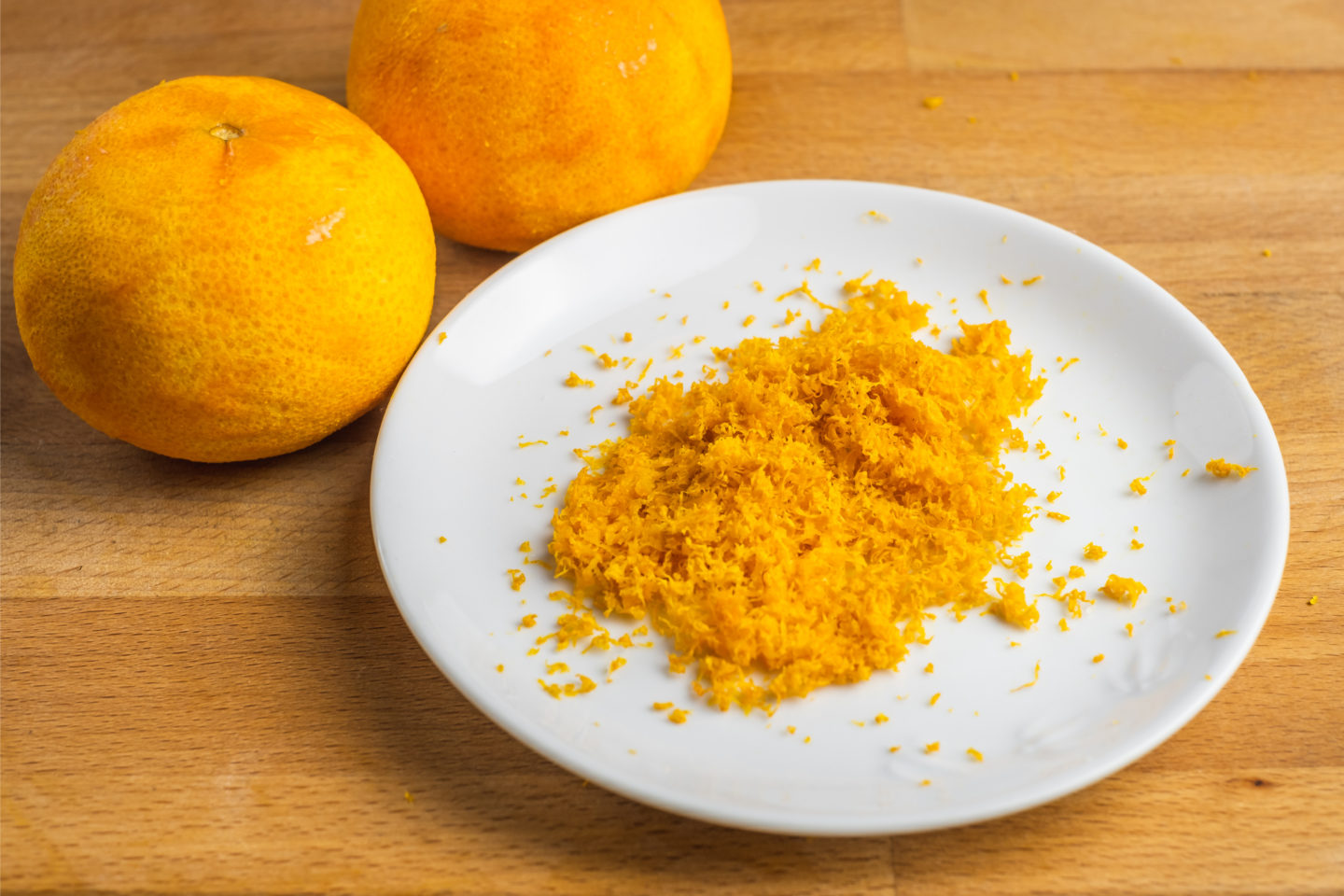 Grated Orange Zest On White Plate