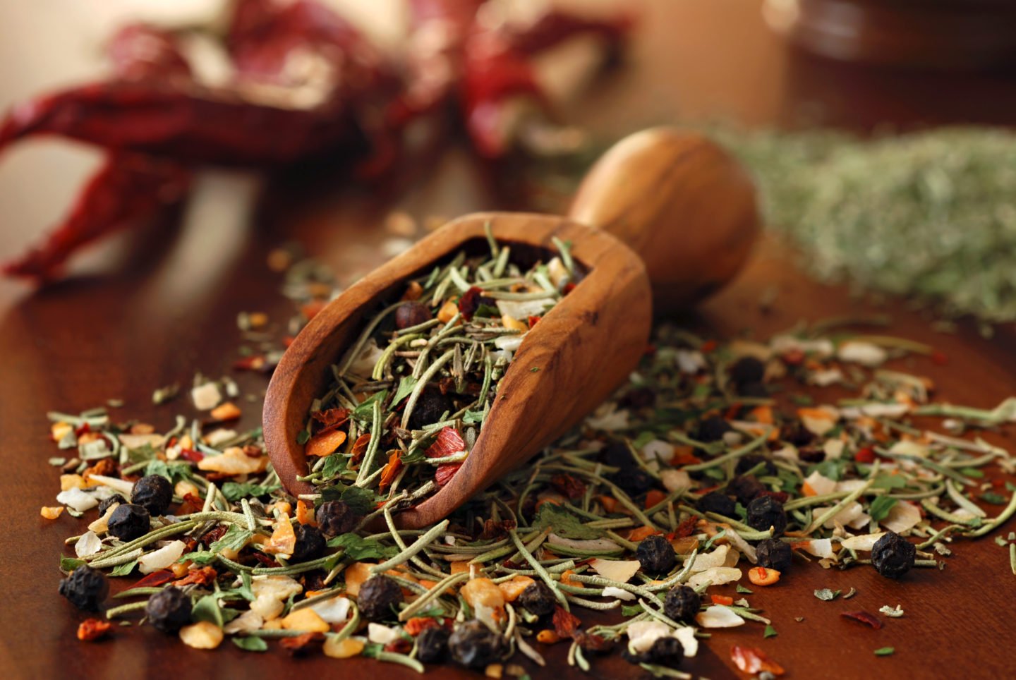 Herb Mix In Wooden Scoop And On Wooden Table