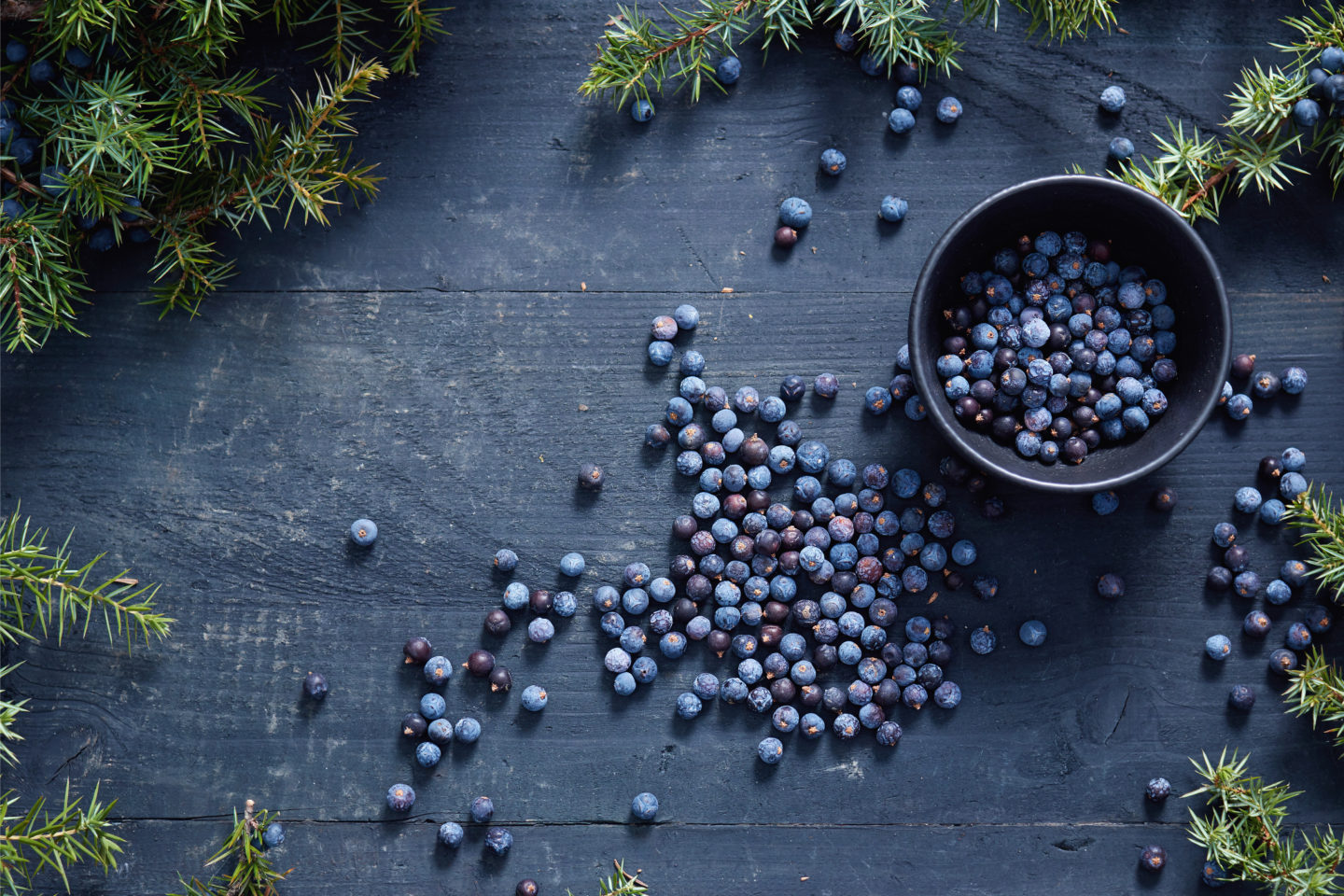 Juniper Berries In And Beside Black Bowl