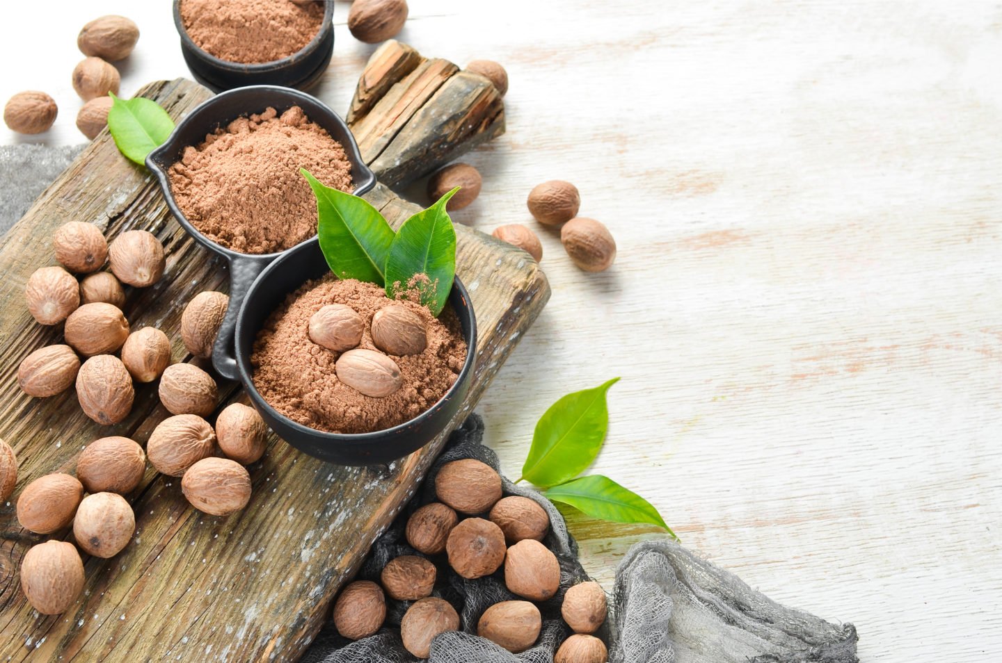 Nutmeg And Ground Nutmeg In Bowls