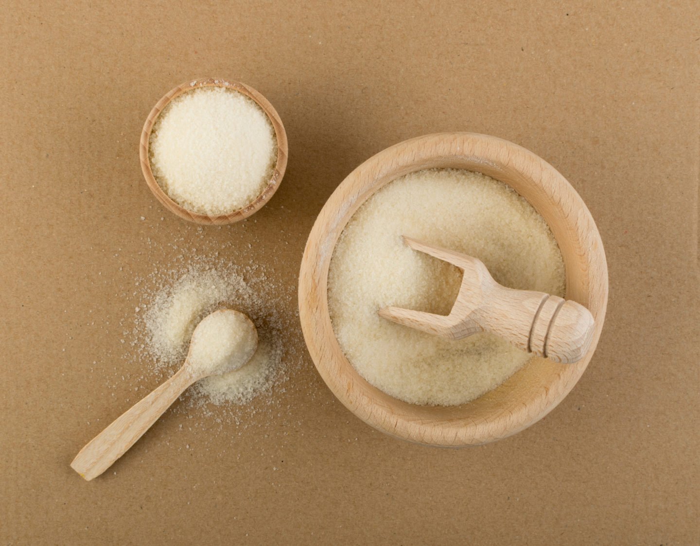 Organic Gelatin Powder In Wooden Bowls And Spoon