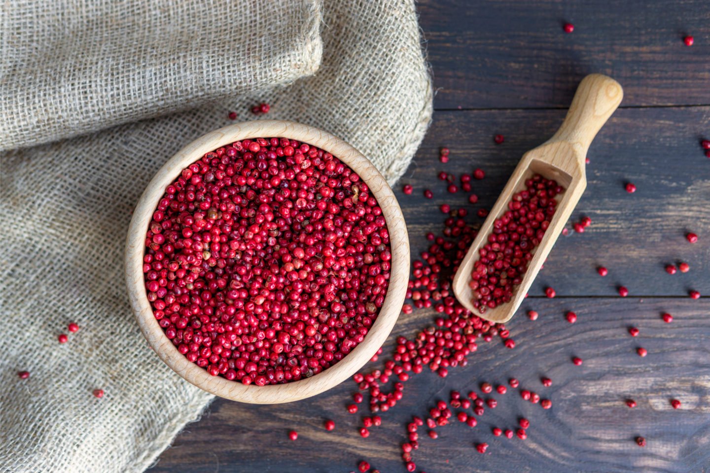Pink Peppercorns In Wooden Bowl And Scoop