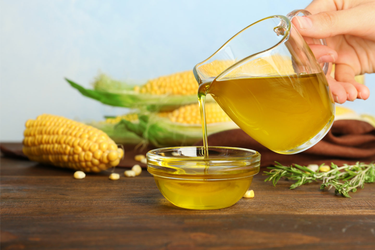 Pouring Fresh Corn Oil Into Glass Bowl