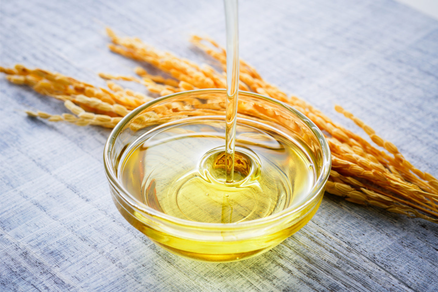 Pouring Rice Bran Oil Into Glass Bowl