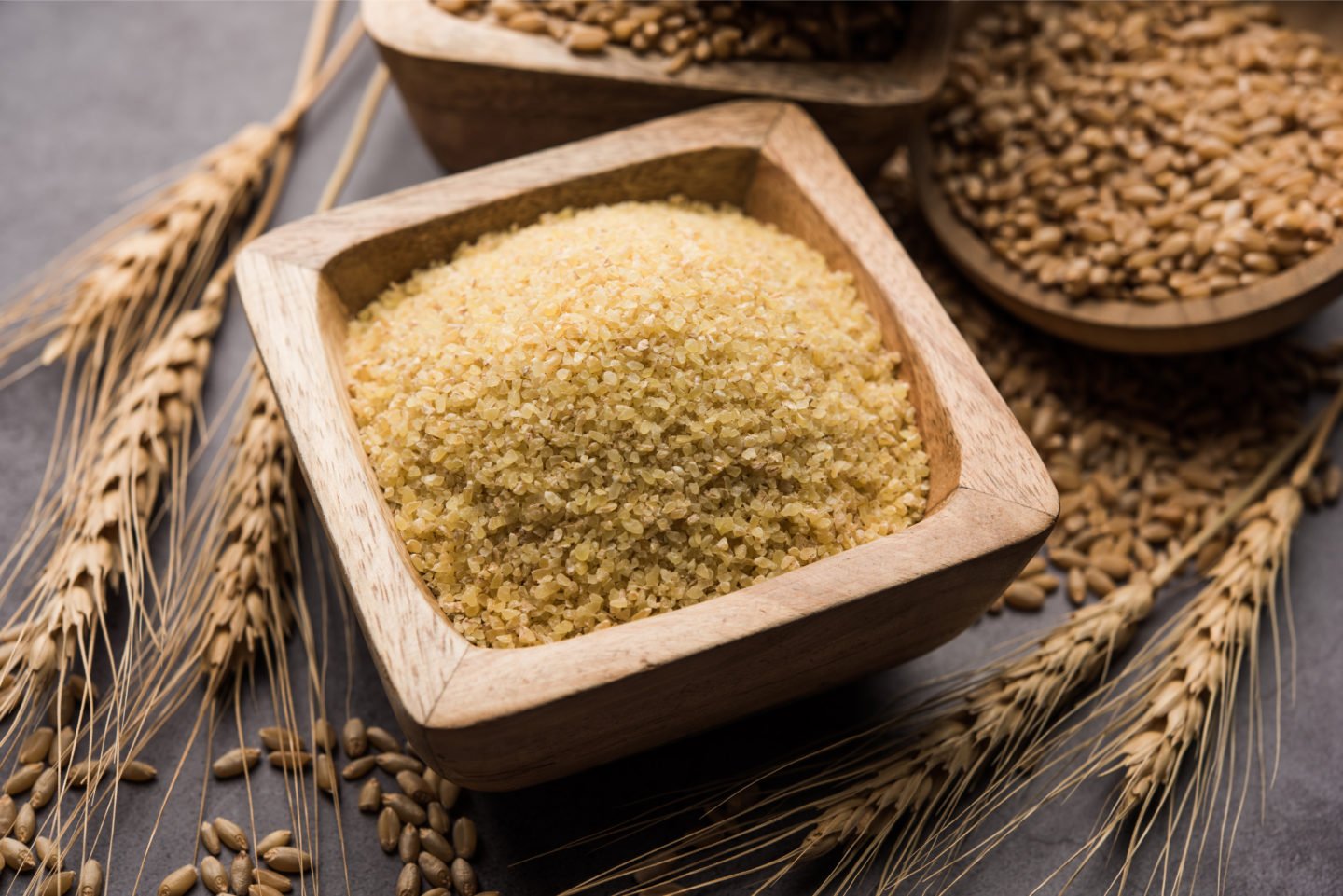 Raw Cracked Wheat In Square Wooden Bowl