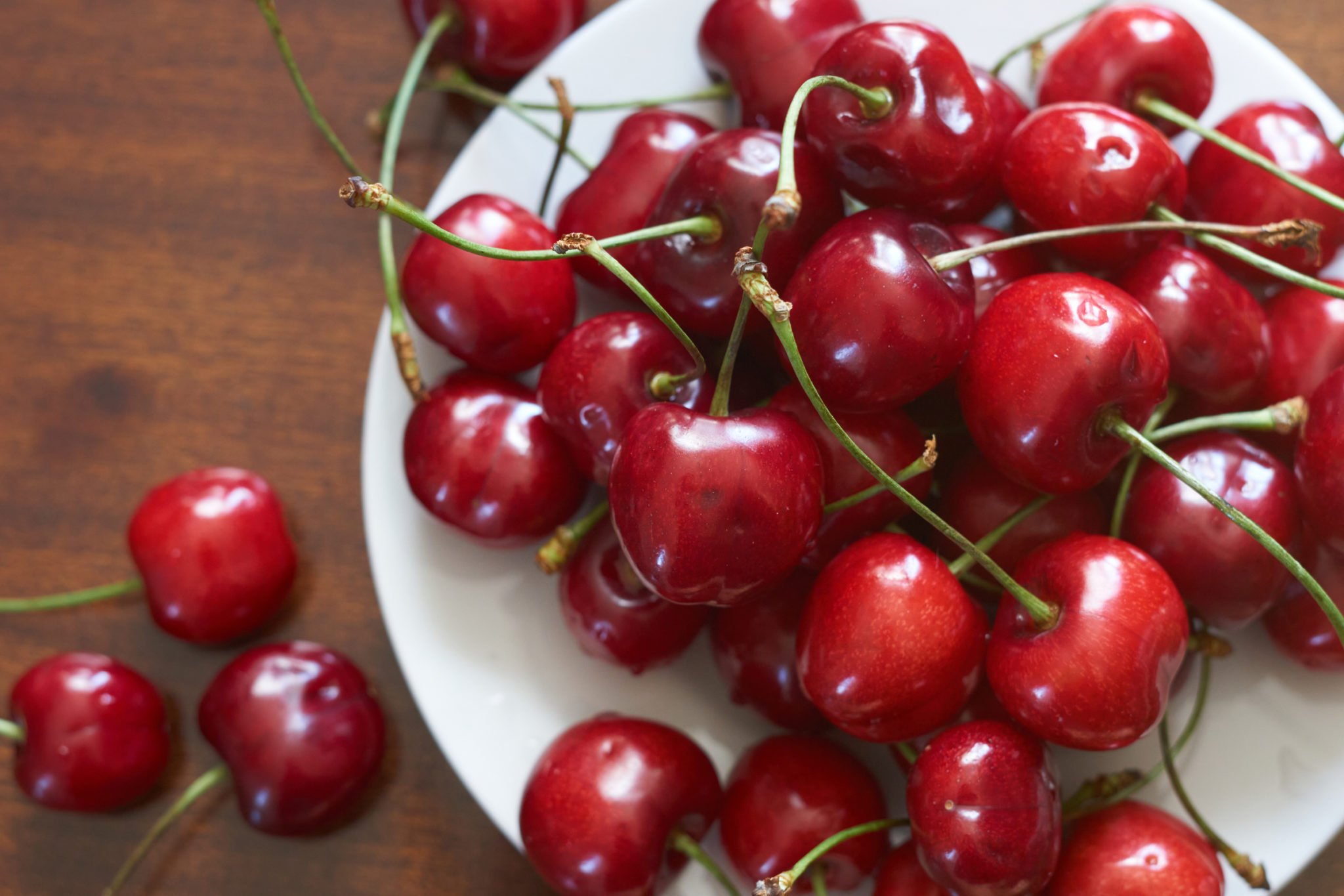 red cherries on white plate