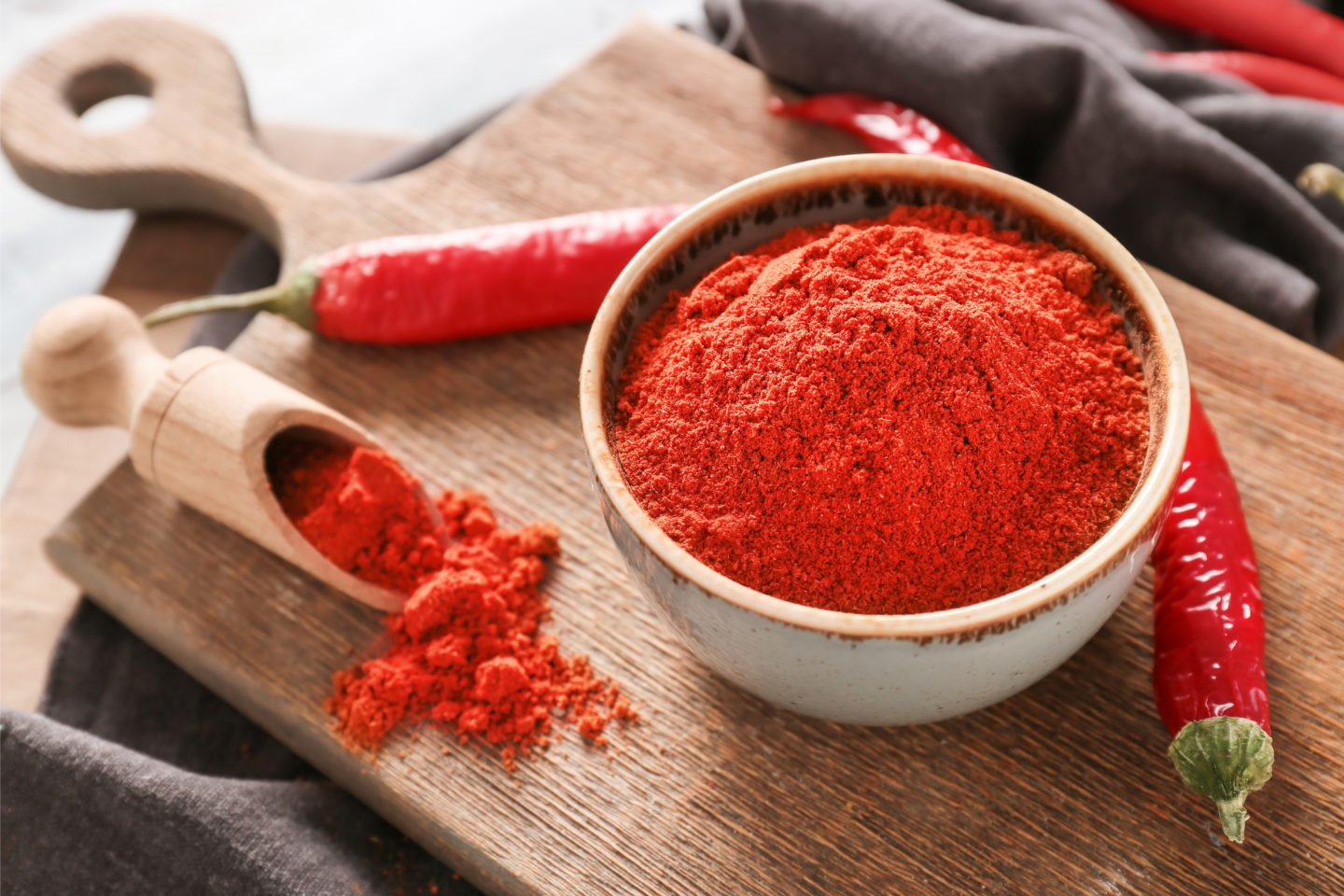 Red Chili Powder In Wooden Bowl And Scoop
