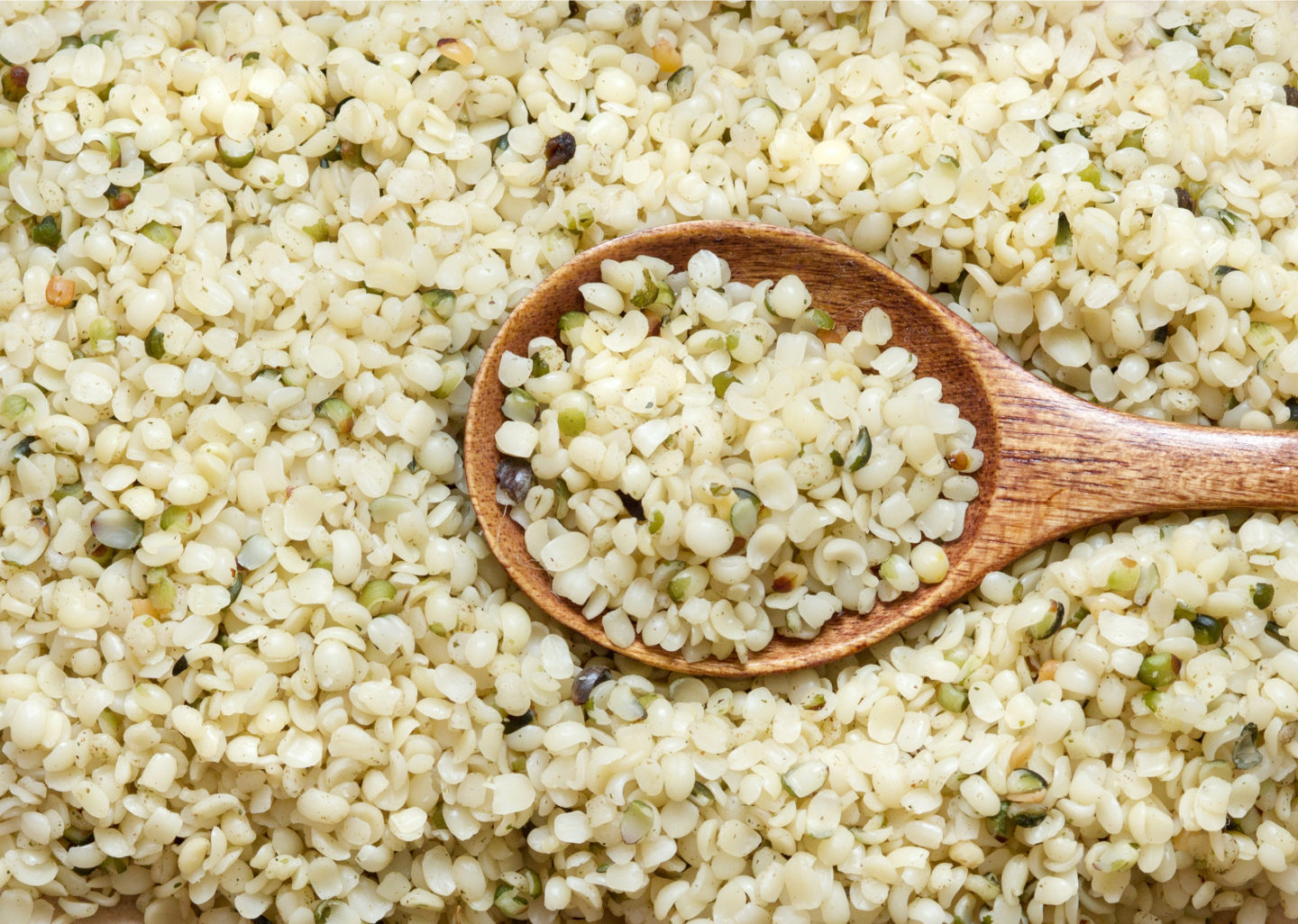 Shelled Hemp Seeds On Wooden Spoon