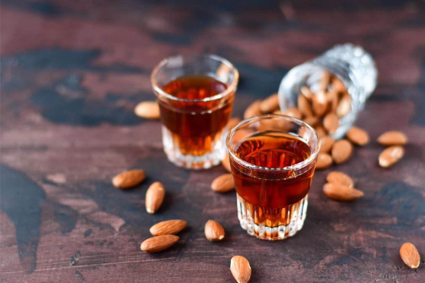 Shots Of Amaretto Beside Almonds