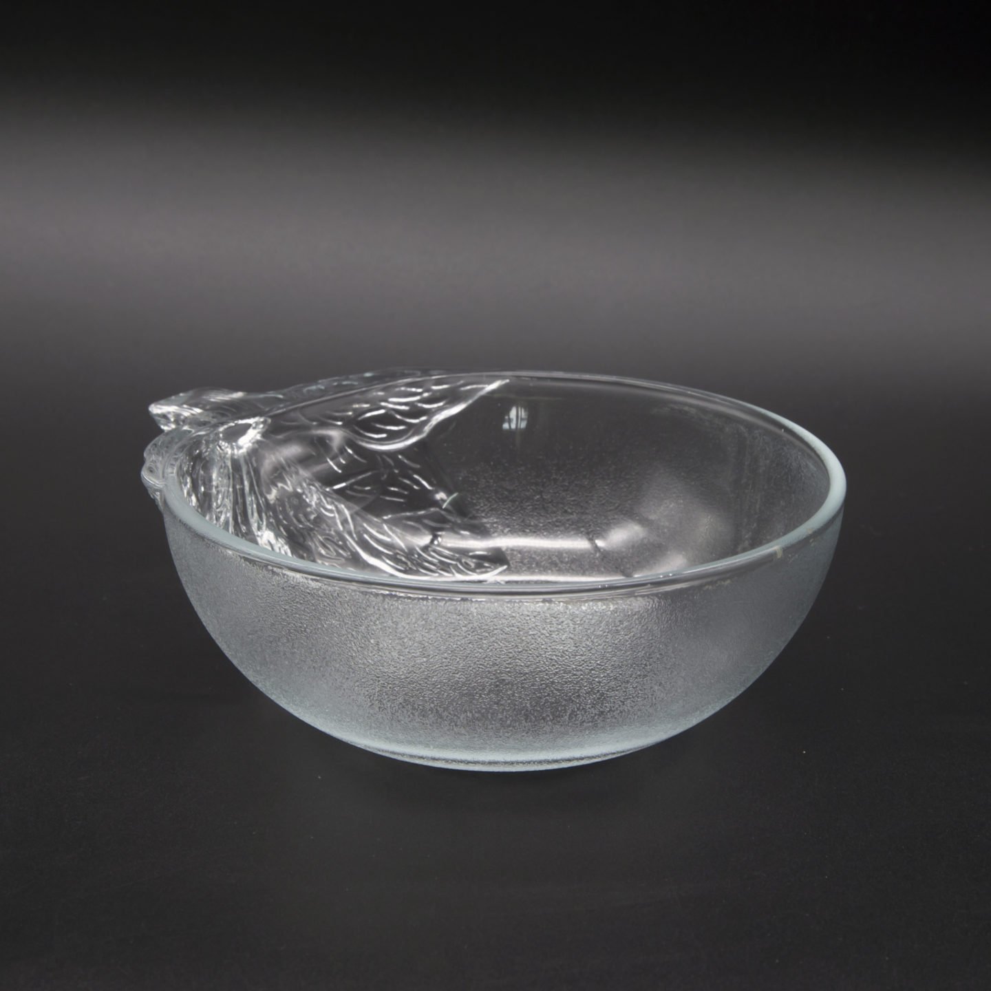 small empty glass bowl black background