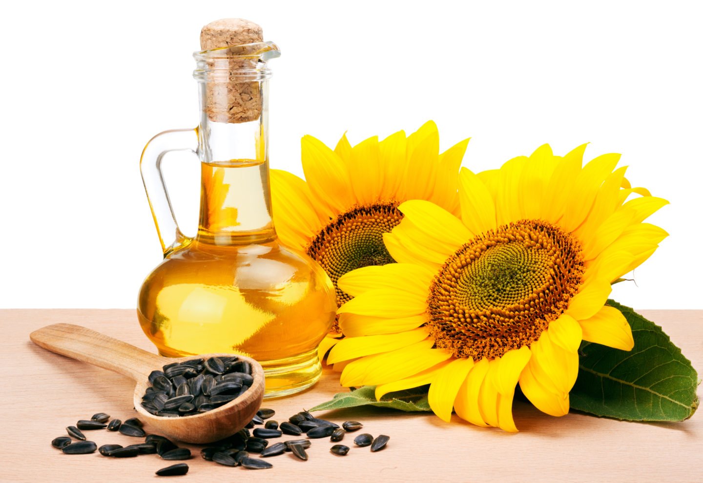 Sunflower Oil Beside Sunflowers And Seeds