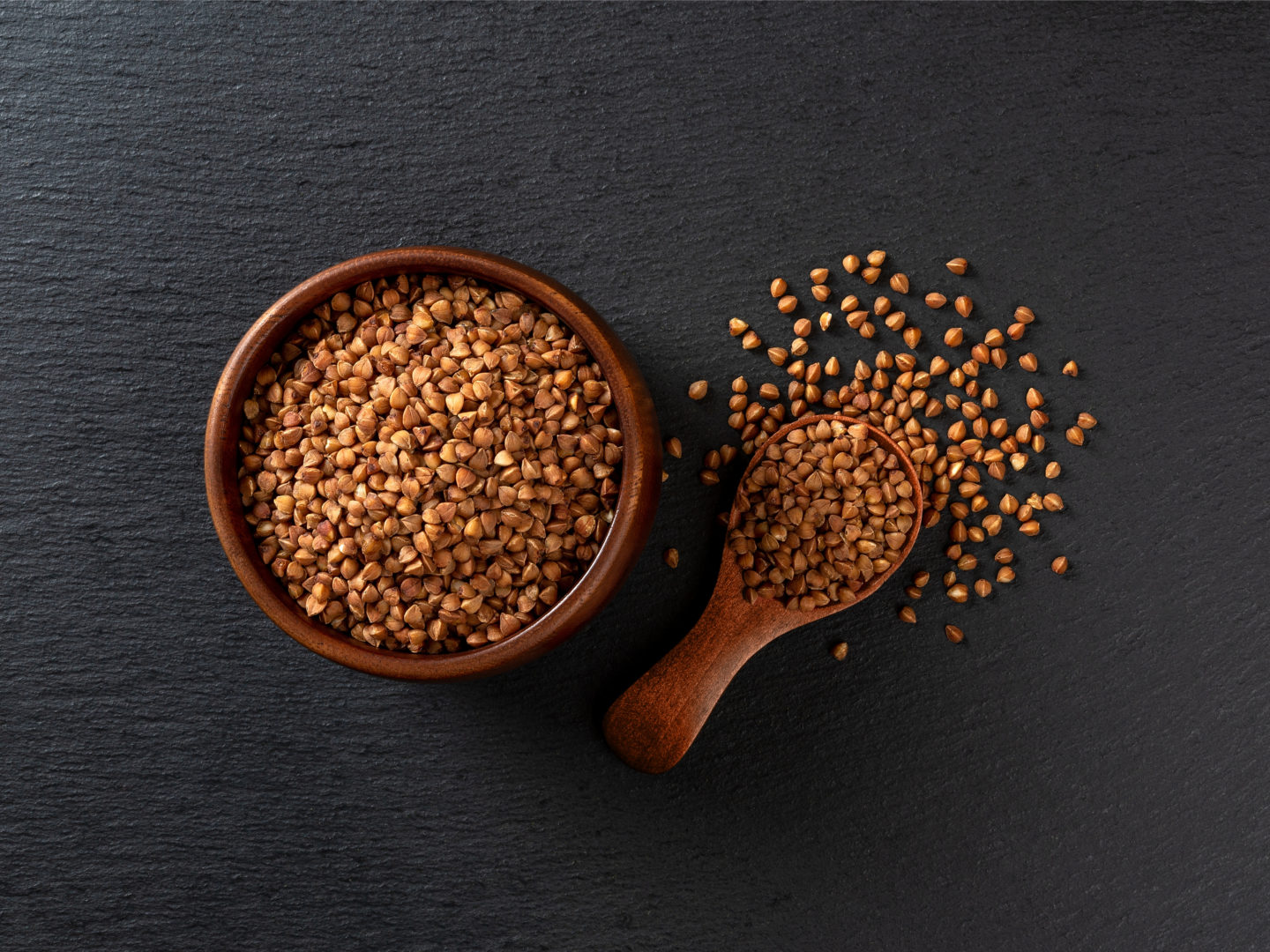 Uncooked Buckwheat In Wooden Bowl And Spoon