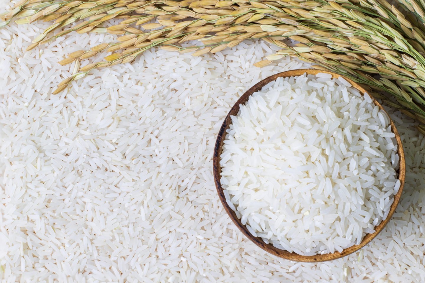 Uncooked Rice In Wooden Bowl And Surface