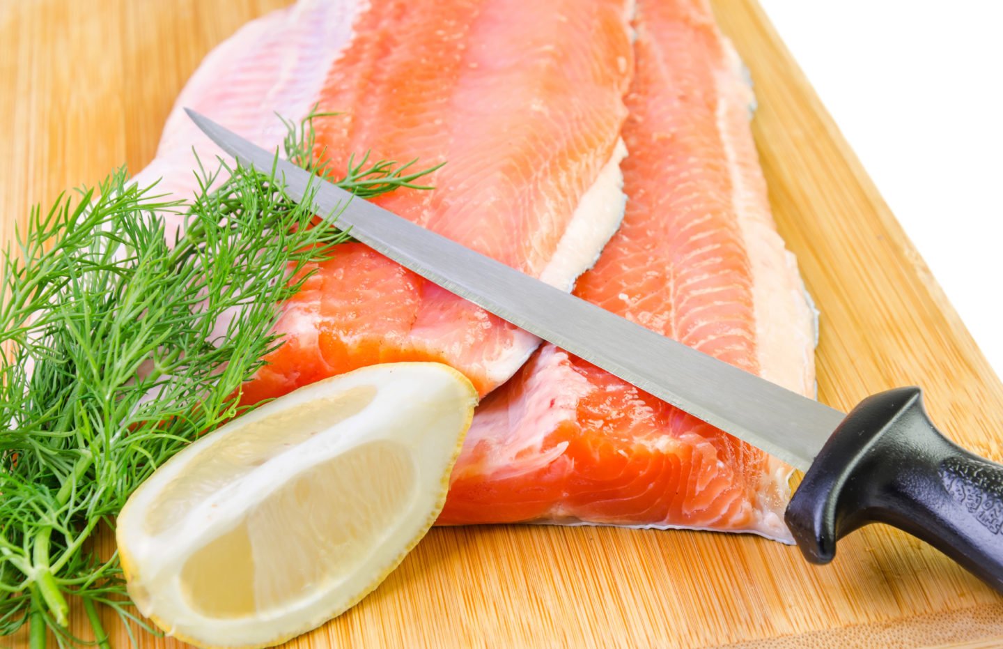 fish fillet knife on top of trout fillets