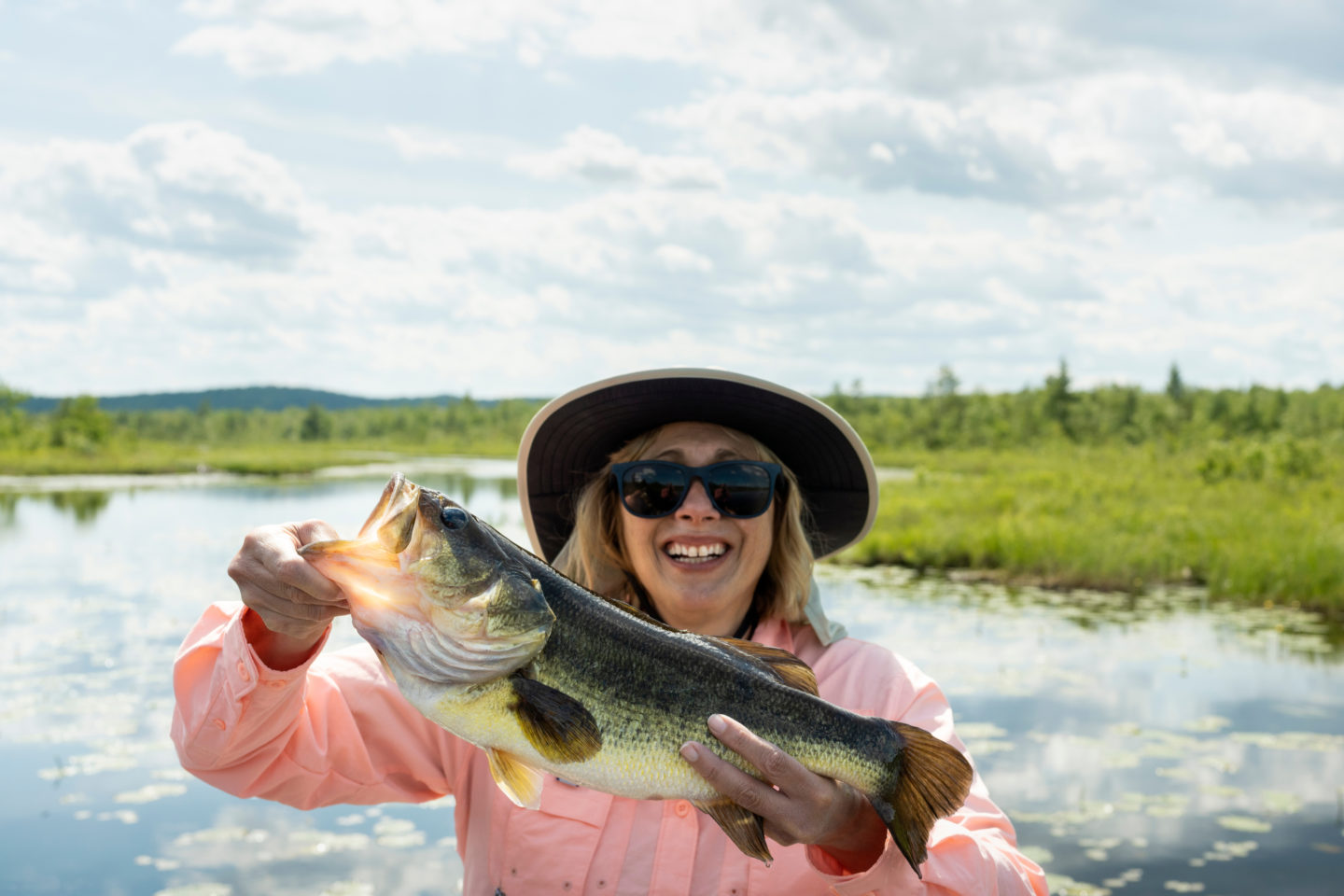 woman holding largemouth bass