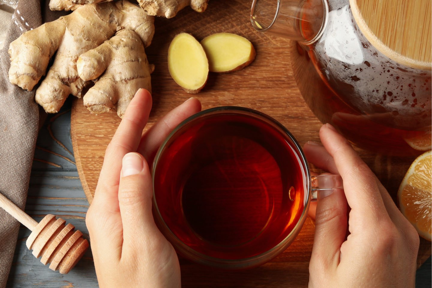 female hands holding cup of ginger tea