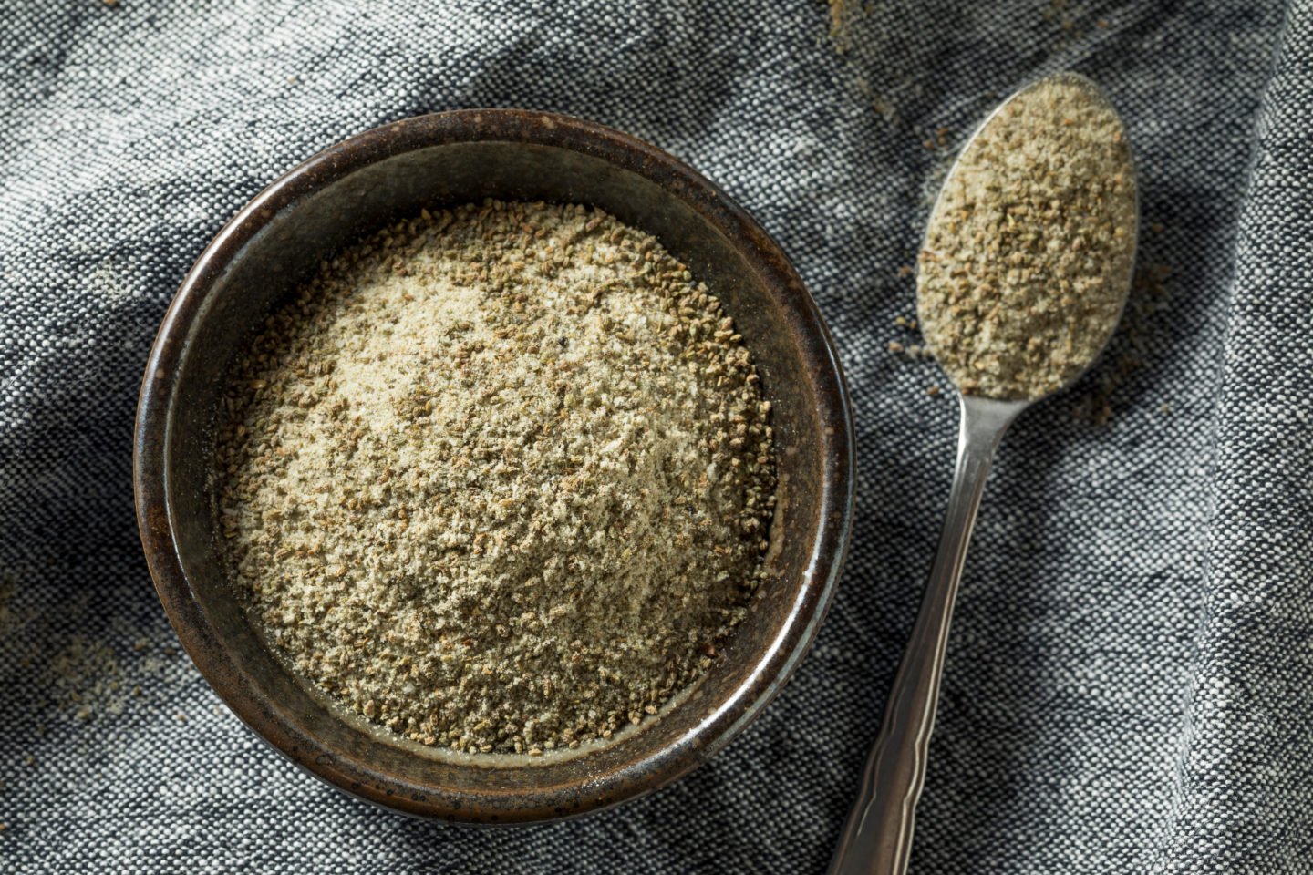 Fresh Celery Salt In Wooden Bowl And Spoon