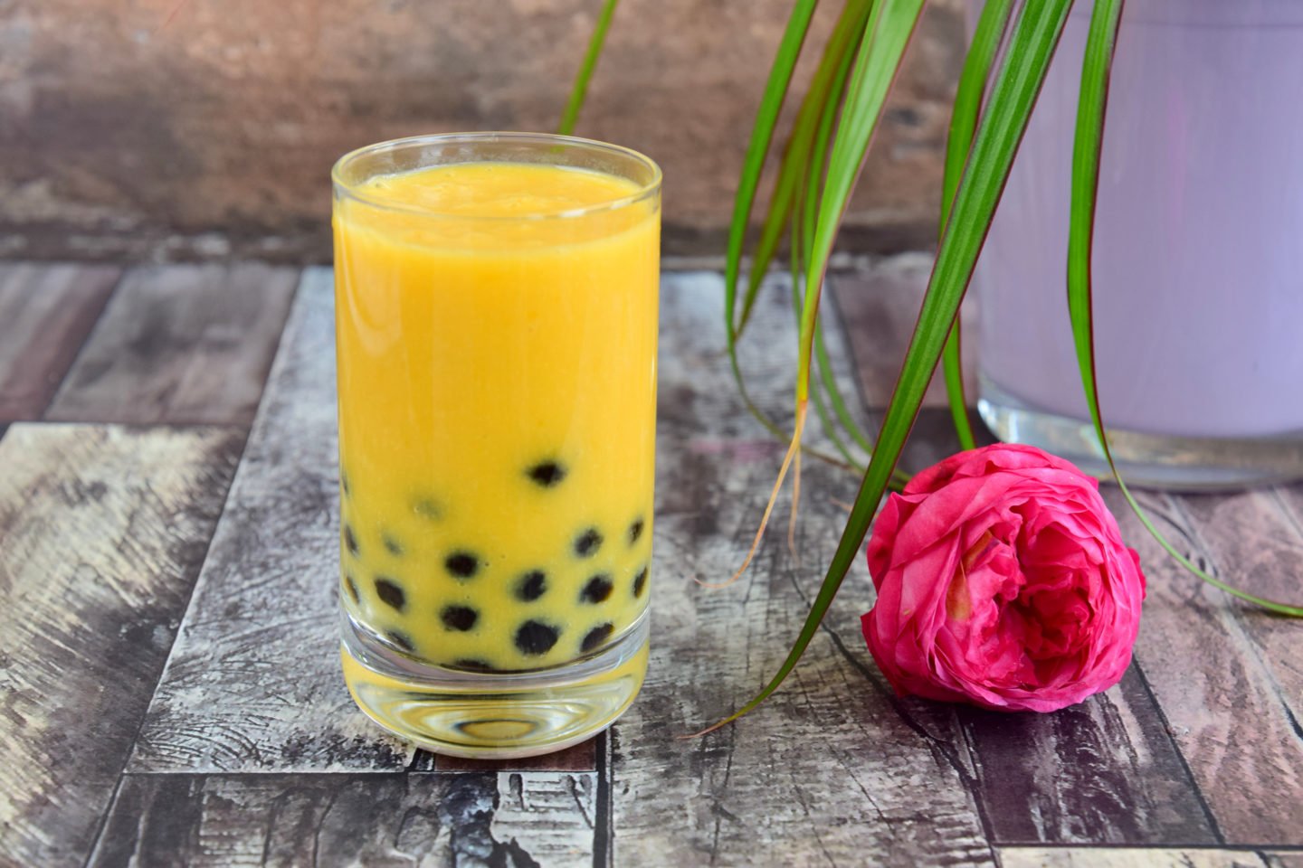 Mango Bubble Tea Beside A Rose