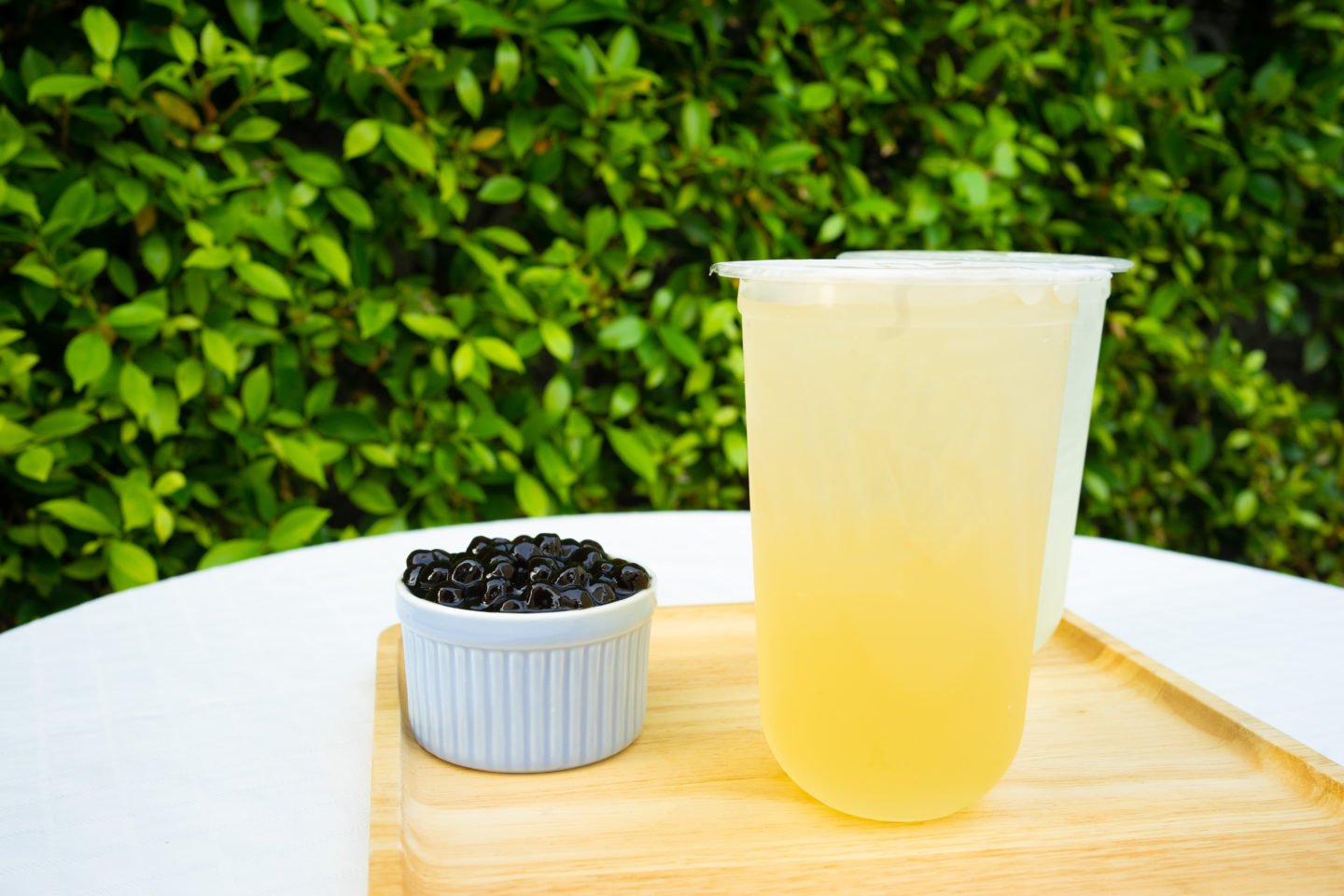 Pineapple Bubble Tea Beside Bowl Of Boba Pearls