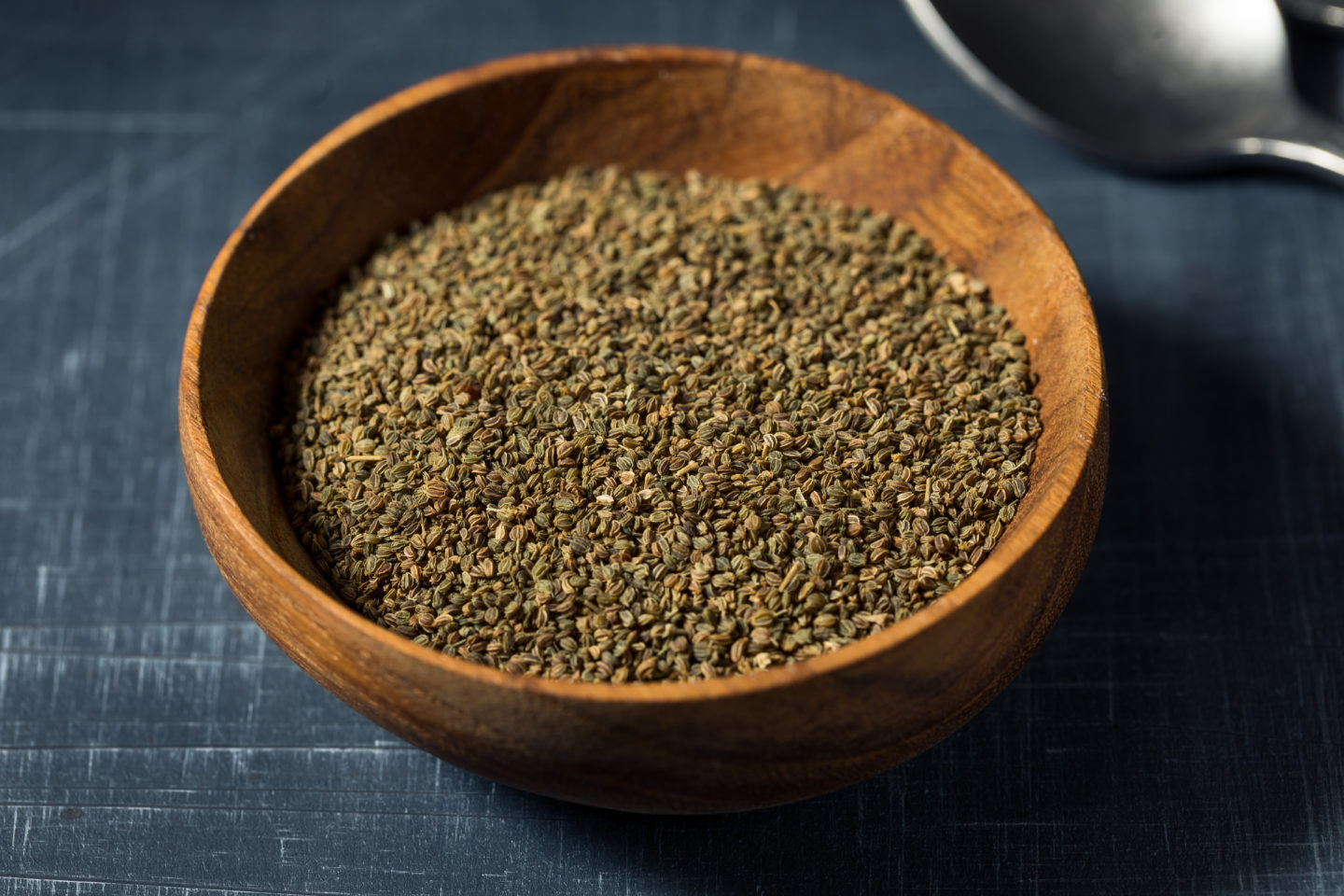 Whole Organic Celery Seeds In Wooden Bowl