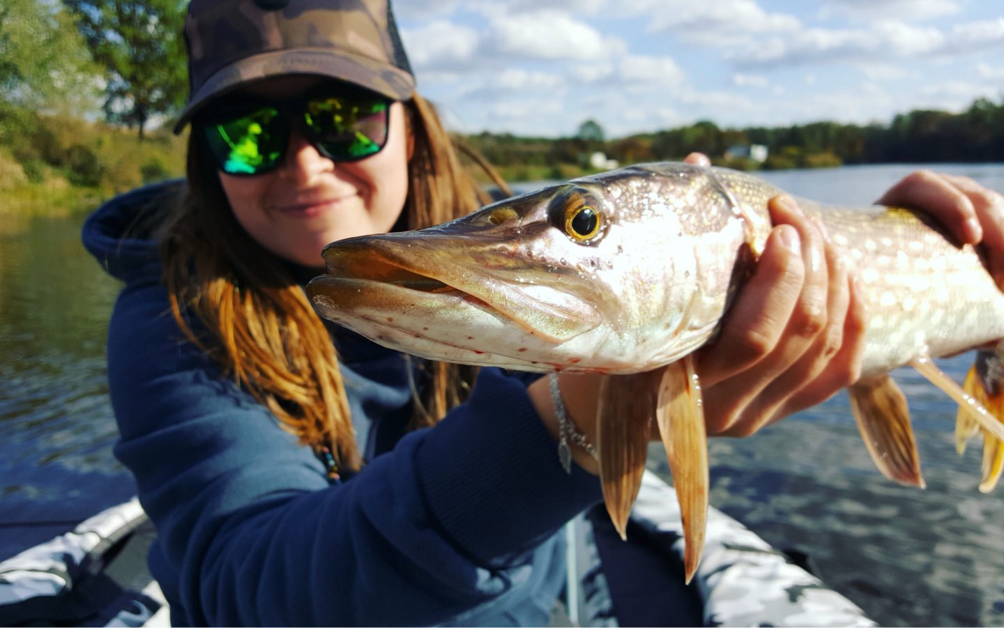 Woman Holding Trophy Pike In River