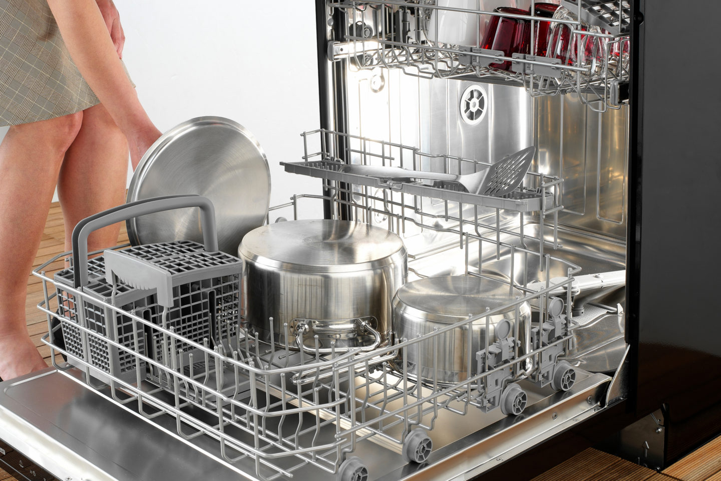 Woman Using Dishwasher